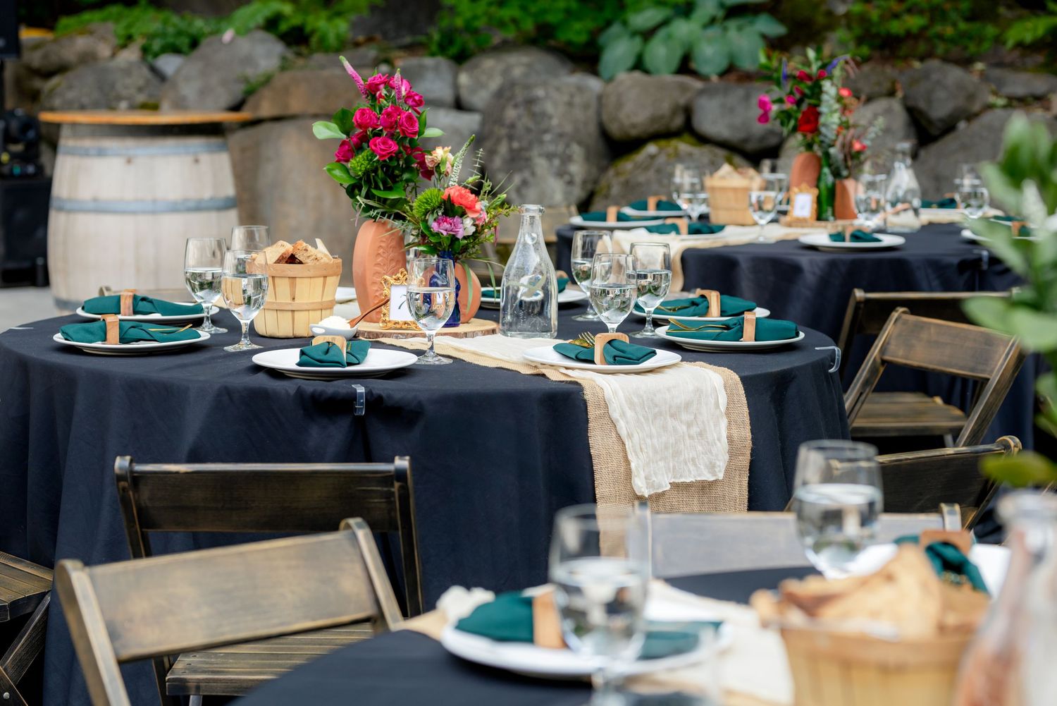 Elegant outdoor wedding reception tables with navy linens.