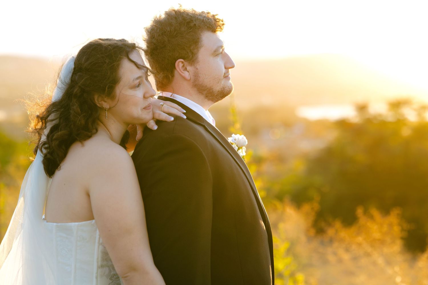A couple shares an intimate moment at sunset during their wedding photoshoot.