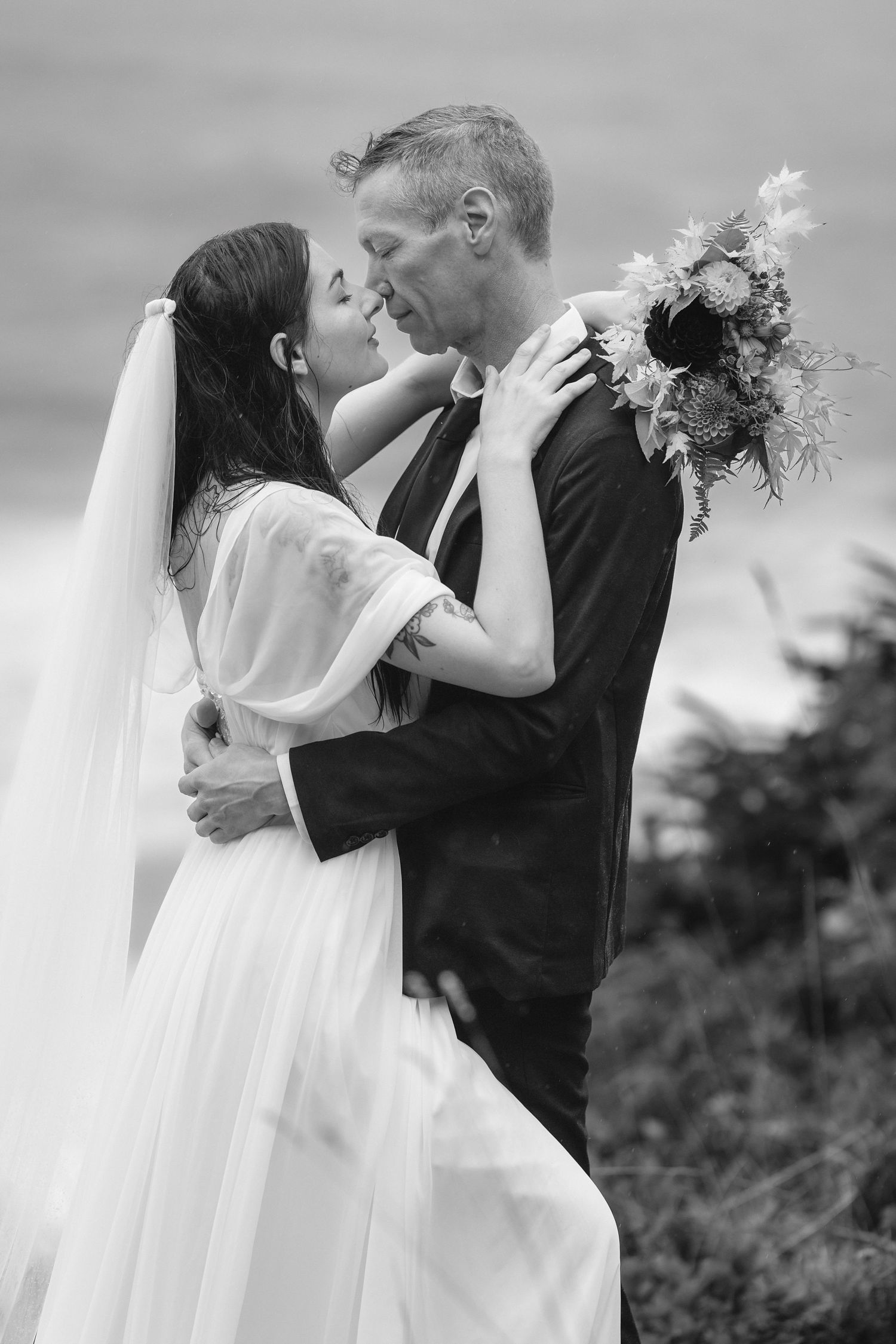 A romantic wedding sequence showing a couple embracing in black and white photos with a flowing veil.