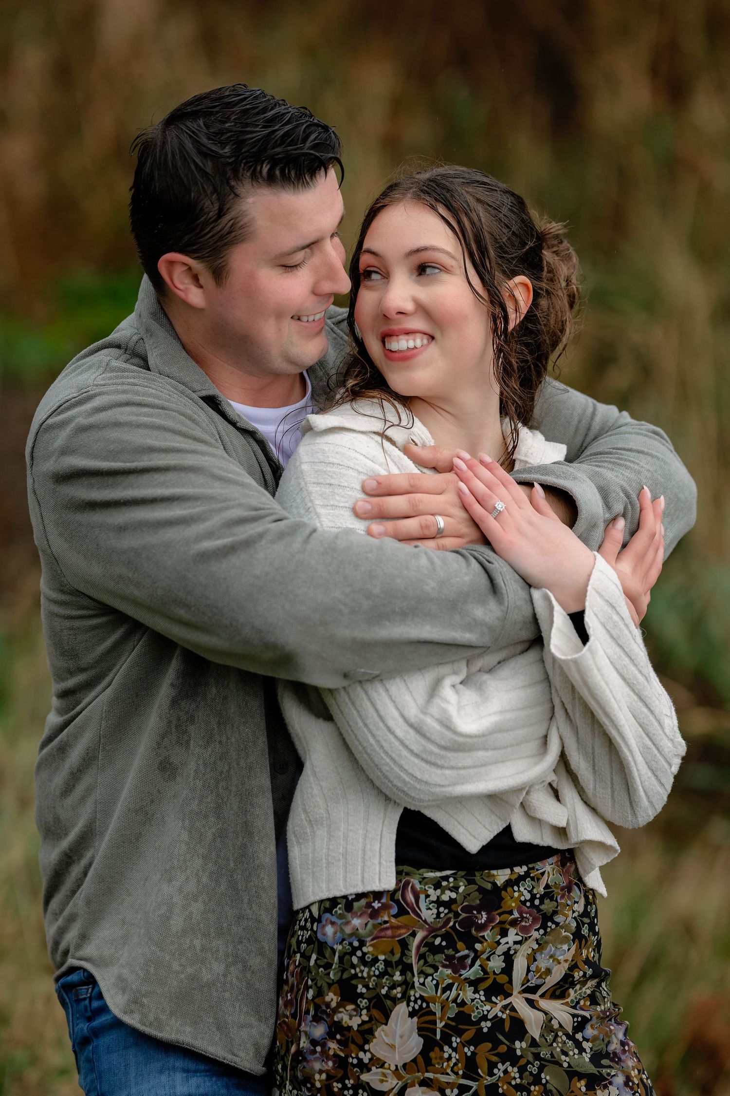 A romantic couple shares intimate moments in a series of casual outdoor portraits wearing grey and floral outfits.