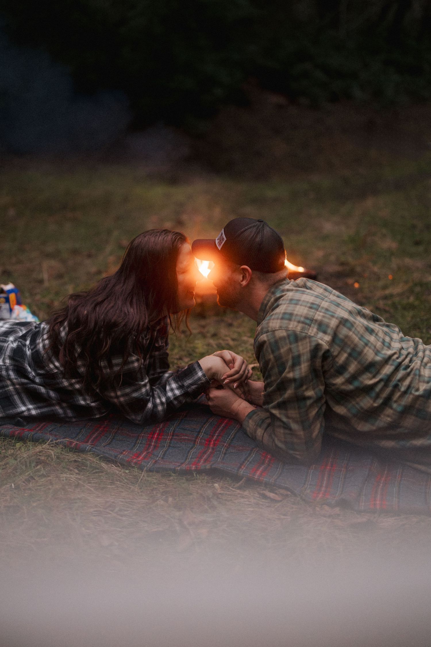 A romantic light painting photo session at dusk with glowing trails of light creating artistic patterns.