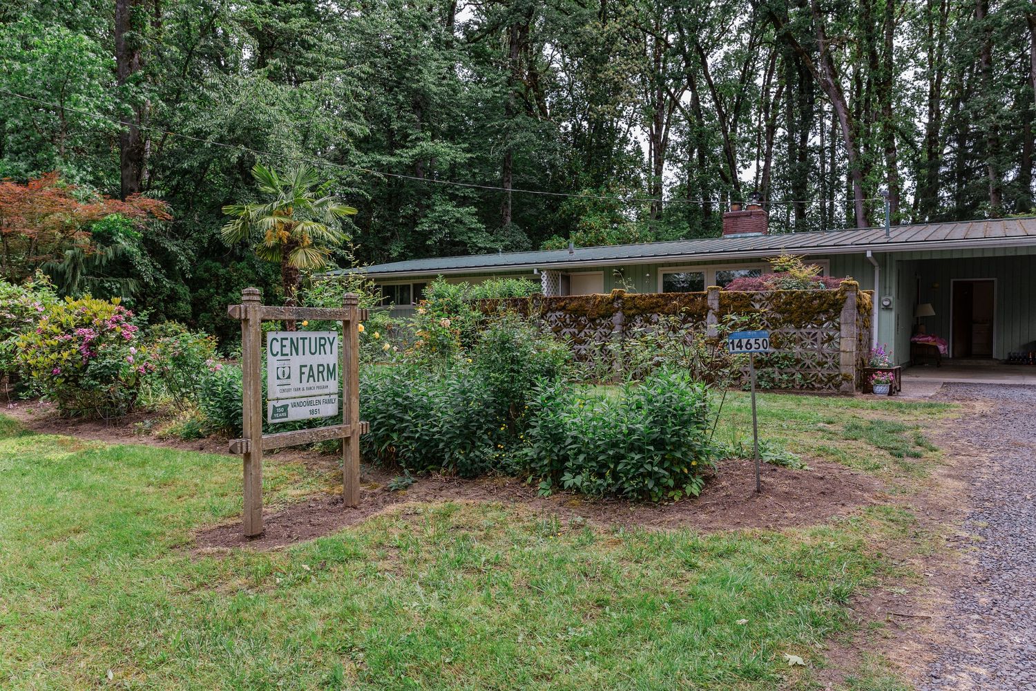 Modern ranch-style venue surrounded by lush greenery and decorated with colorful flowers.