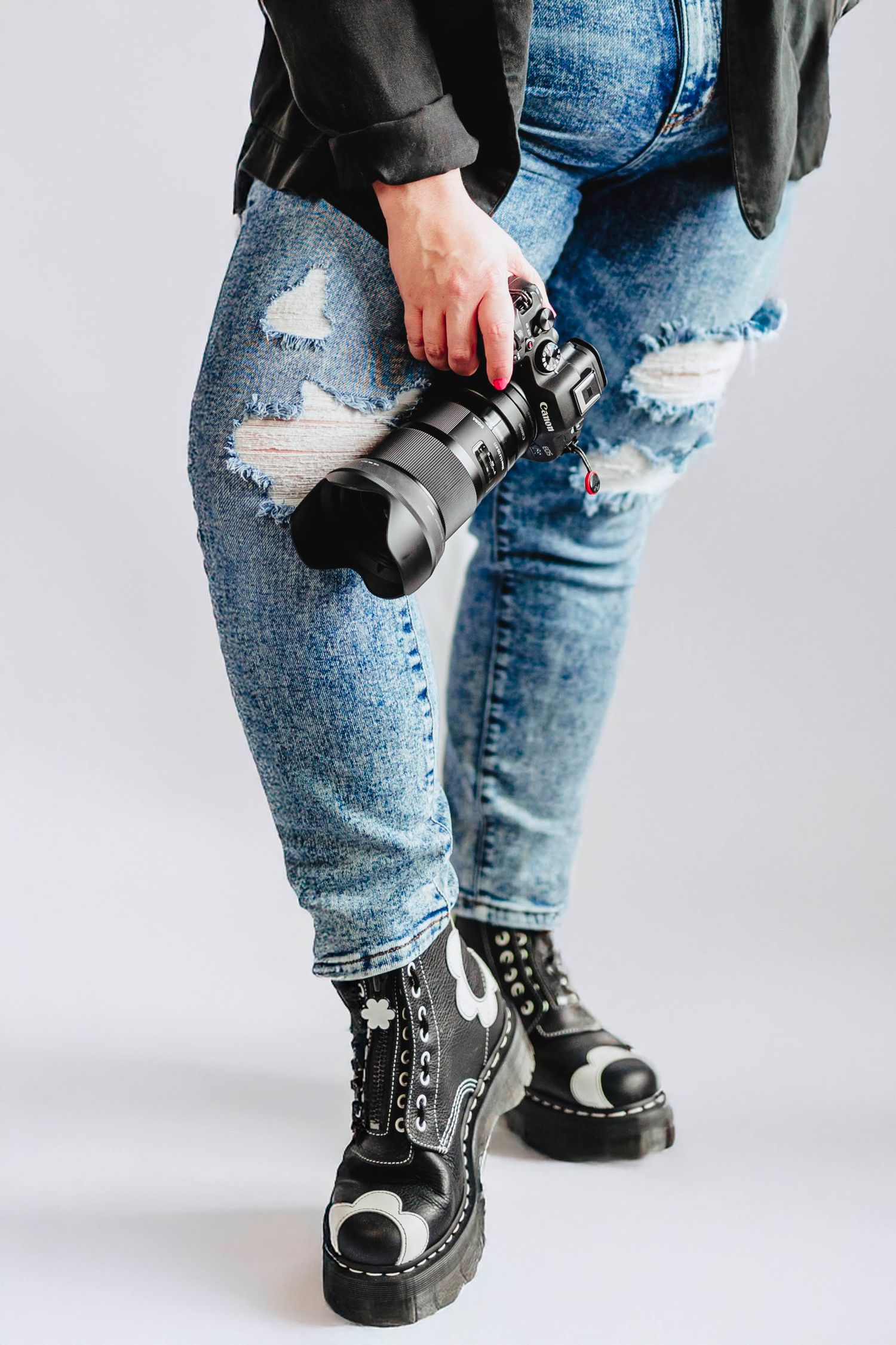 Close-up shots of distressed denim jeans and black combat boots against grey background.