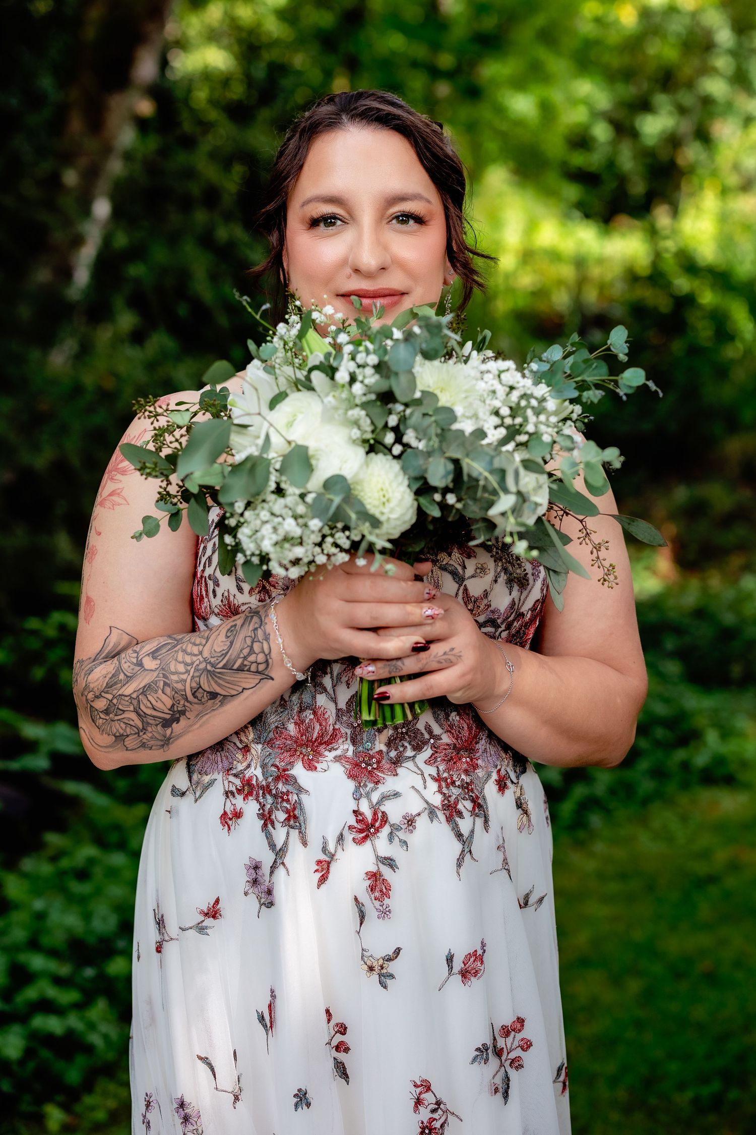 A floral wedding photo series featuring a white dress with red flowers and eucalyptus bouquet details.
