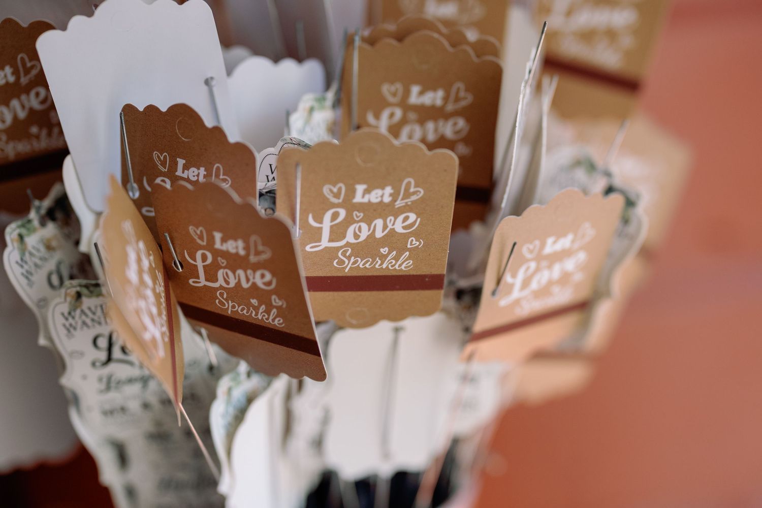 Rustic wooden signs with 'Love' text displayed at a wedding or romantic event.