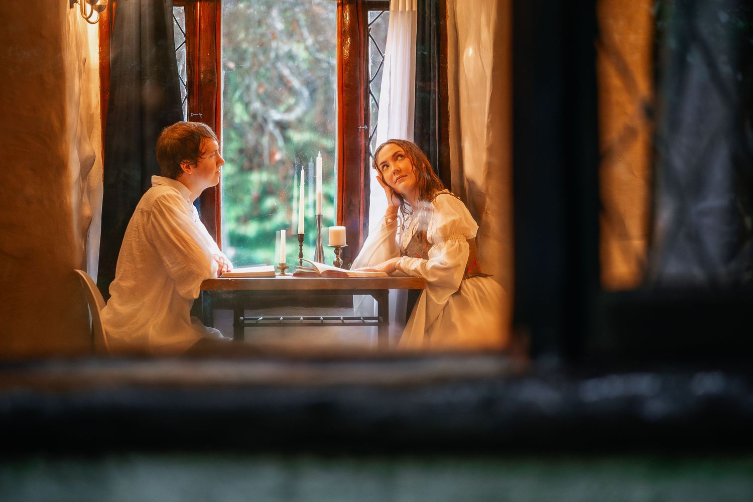 Warm-toned interior shots through window frames creating romantic vignettes.