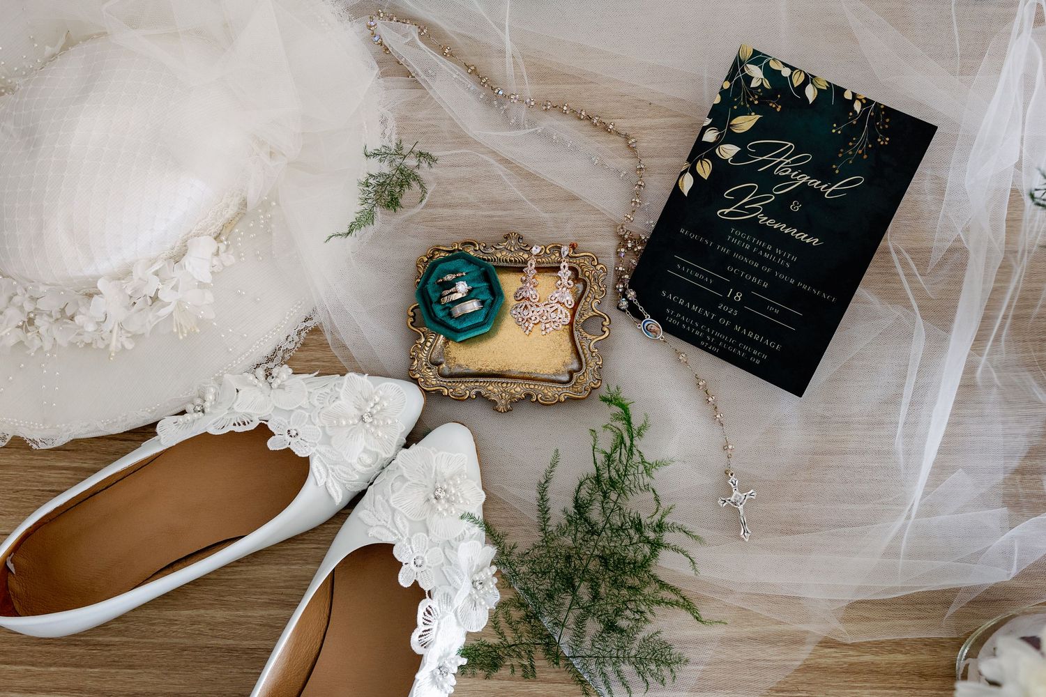 Elegant wedding details featuring white floral arrangements, greenery, and delicate table settings with gold accents.