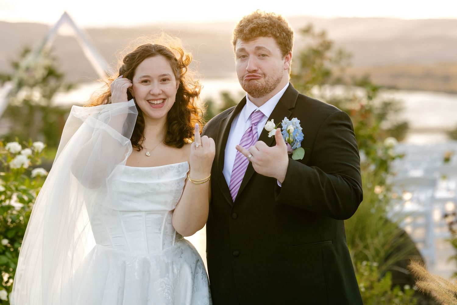 A joyful wedding celebration moment captured outdoors at sunset with mountains in the background.