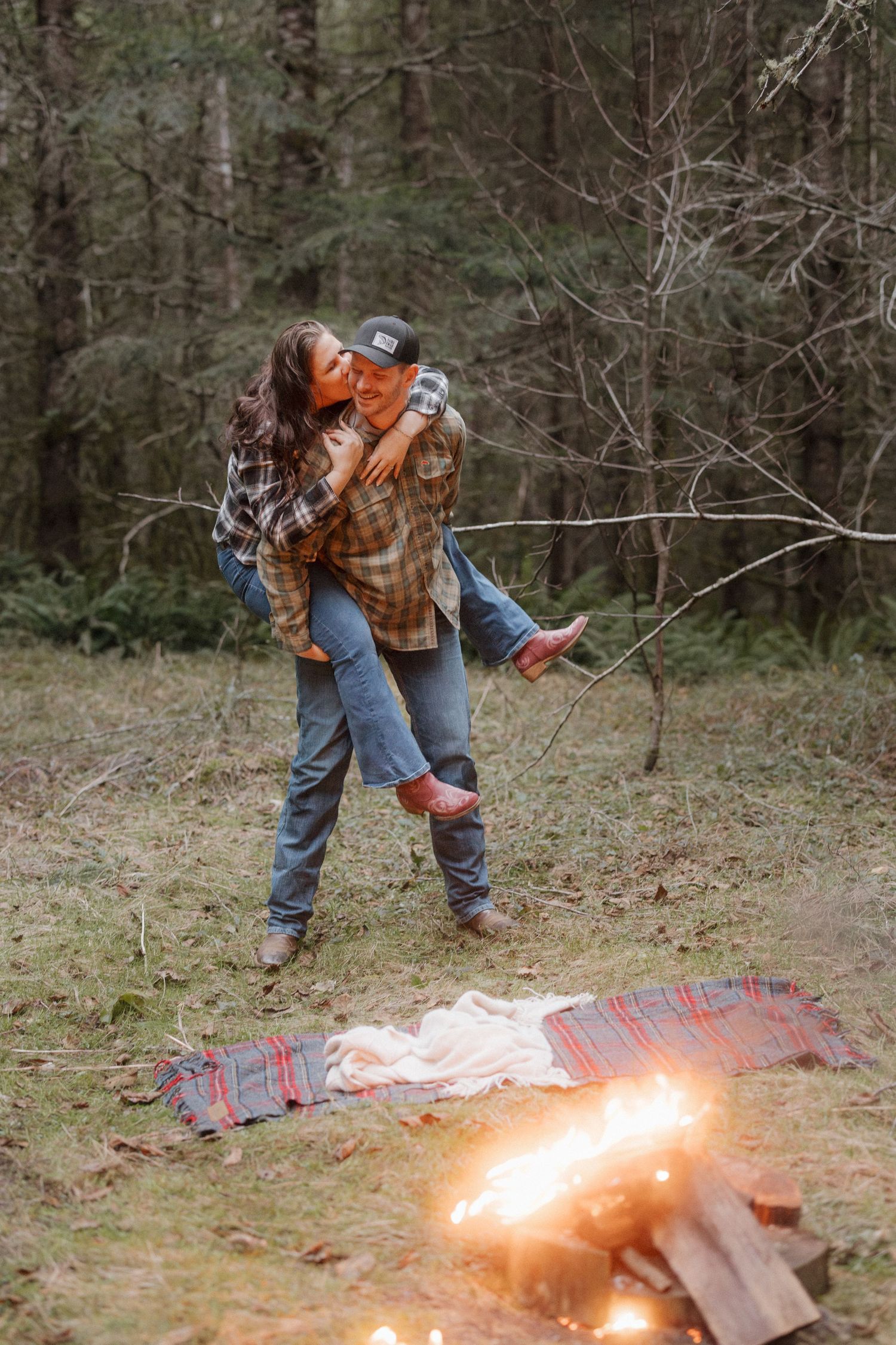 A sequence of images showing a person lighting a cardboard box on fire in a wooded outdoor area.