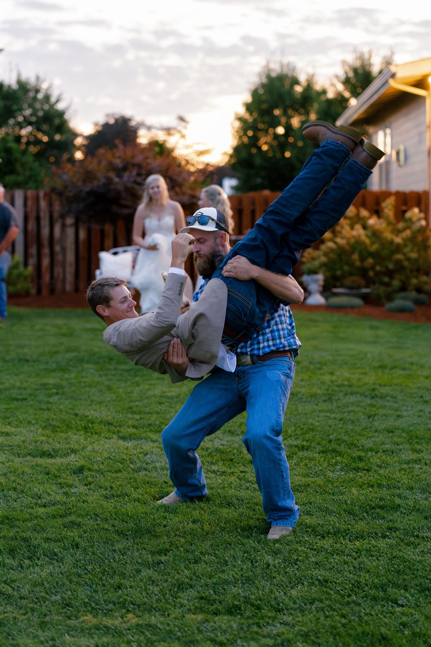 Playful backflip sequence photos on a grassy lawn during sunset wedding celebration.