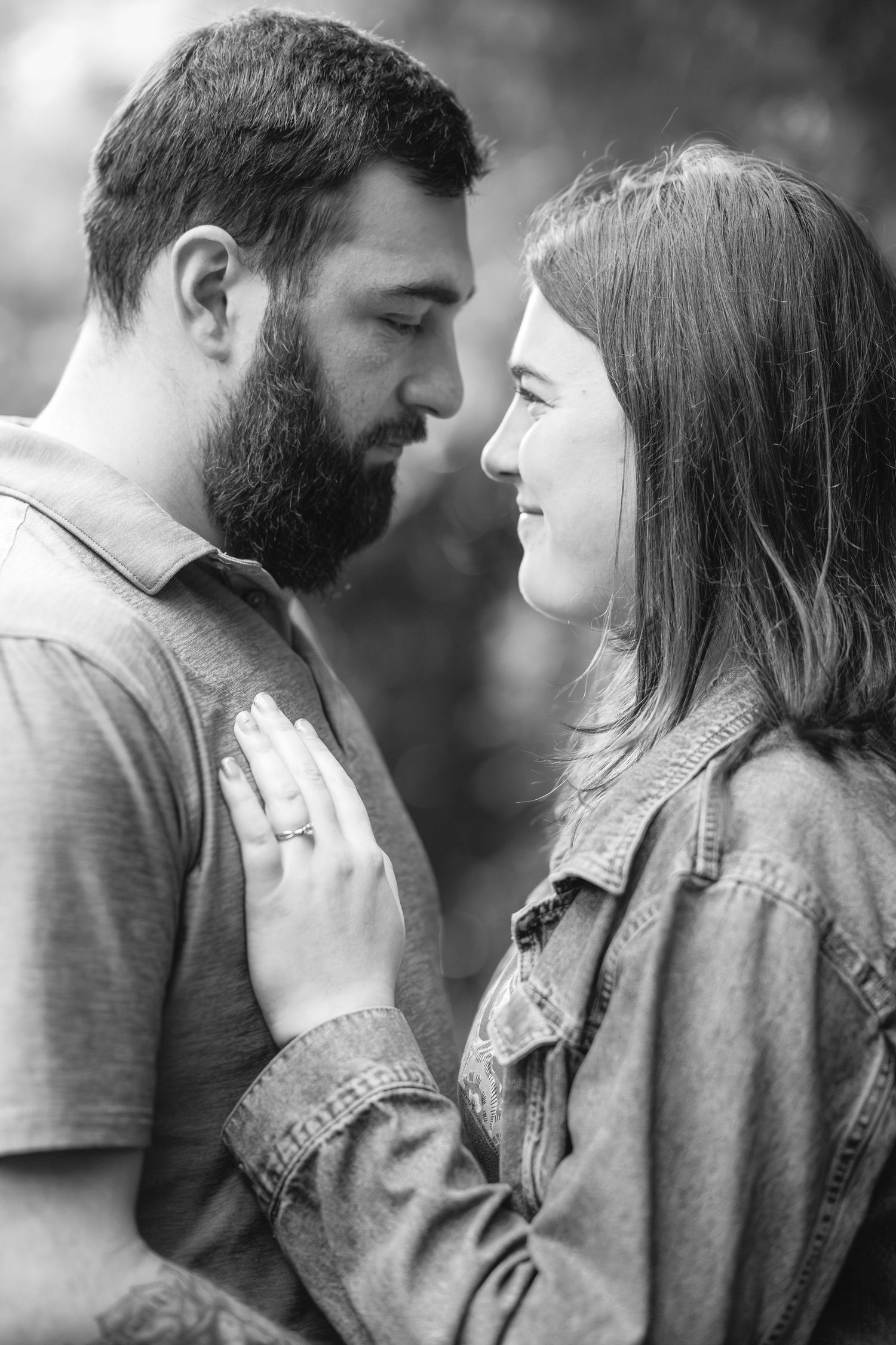 A romantic couple shares an intimate moment together in black and white photography.