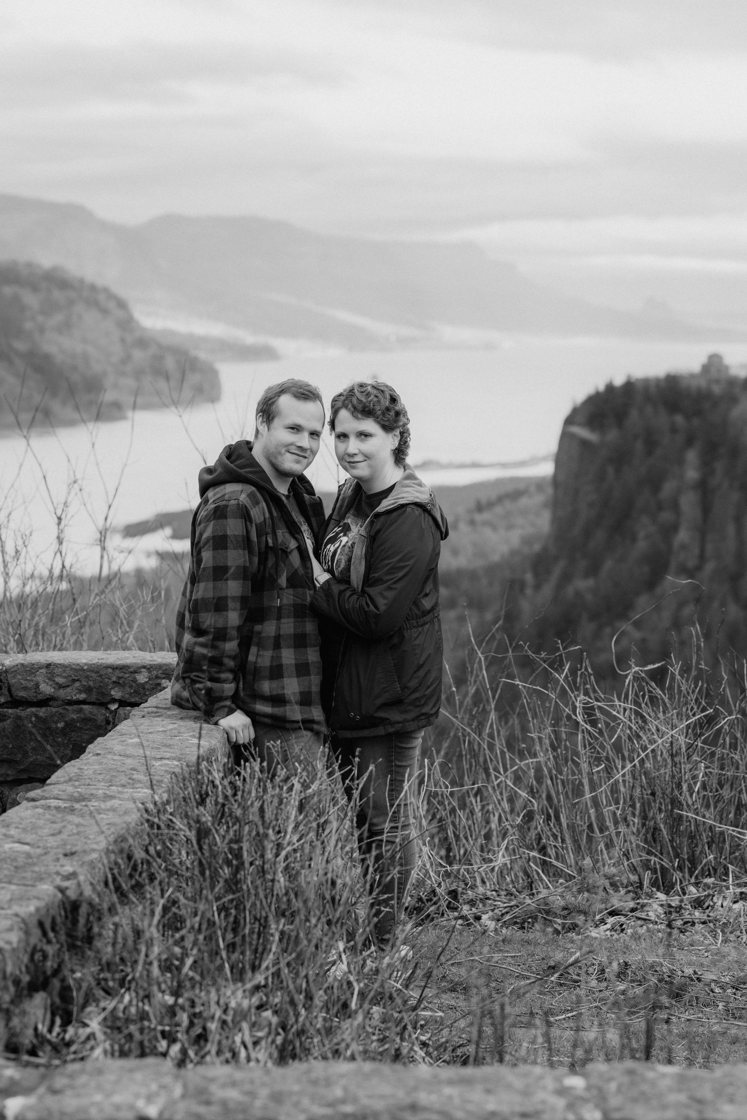 Dramatic cliffside overlook of the Columbia River Gorge with tall grass in the foreground.
