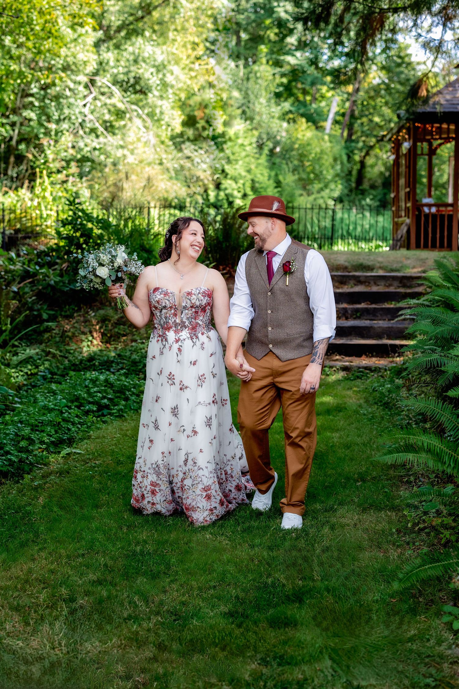 Candid wedding photography session in a lush garden setting with rustic steps.