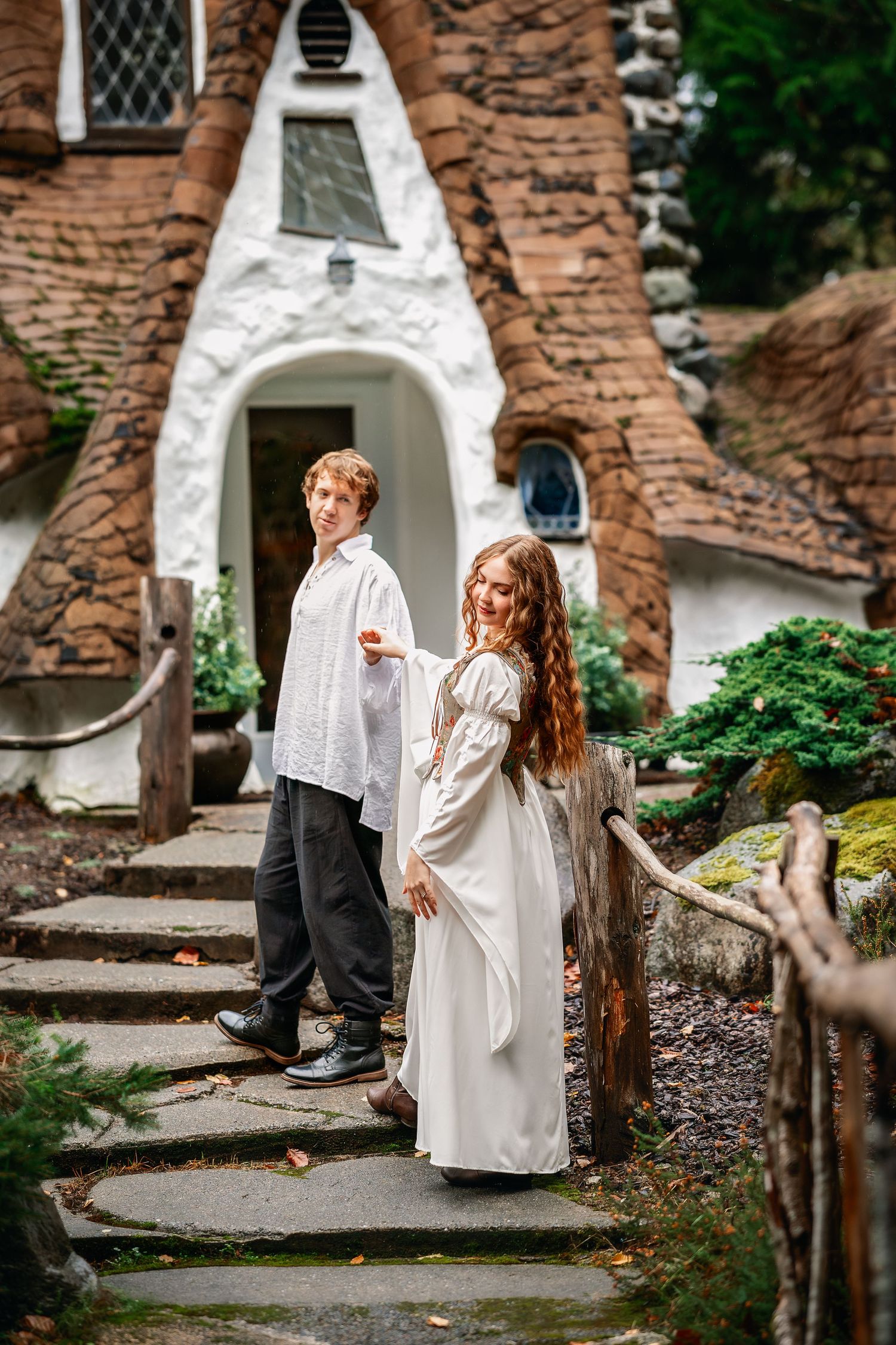 White stone archways and walls create a magical garden pathway setting.