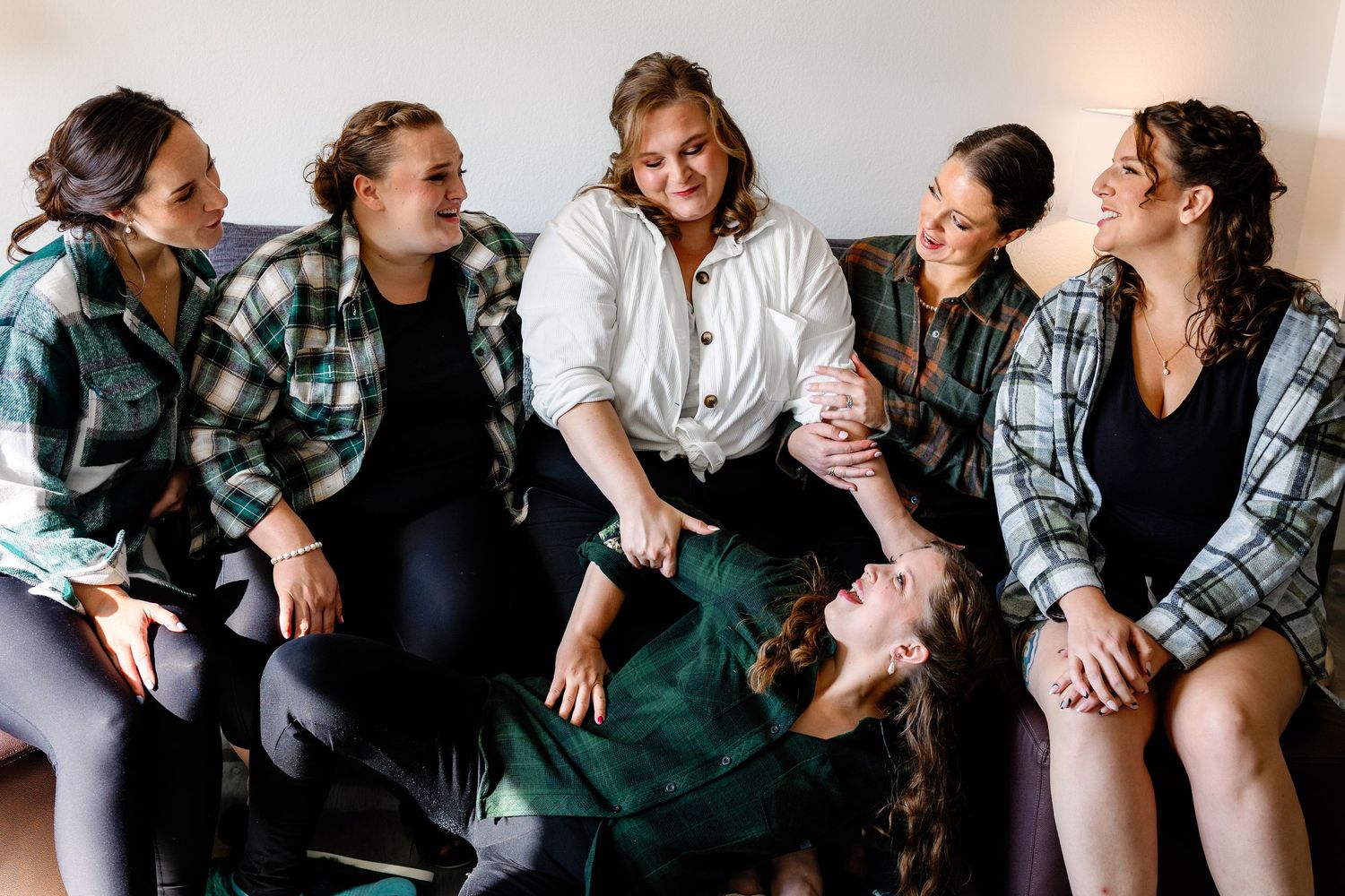 A series of candid black and white photos showing people laughing and enjoying themselves while sitting together.