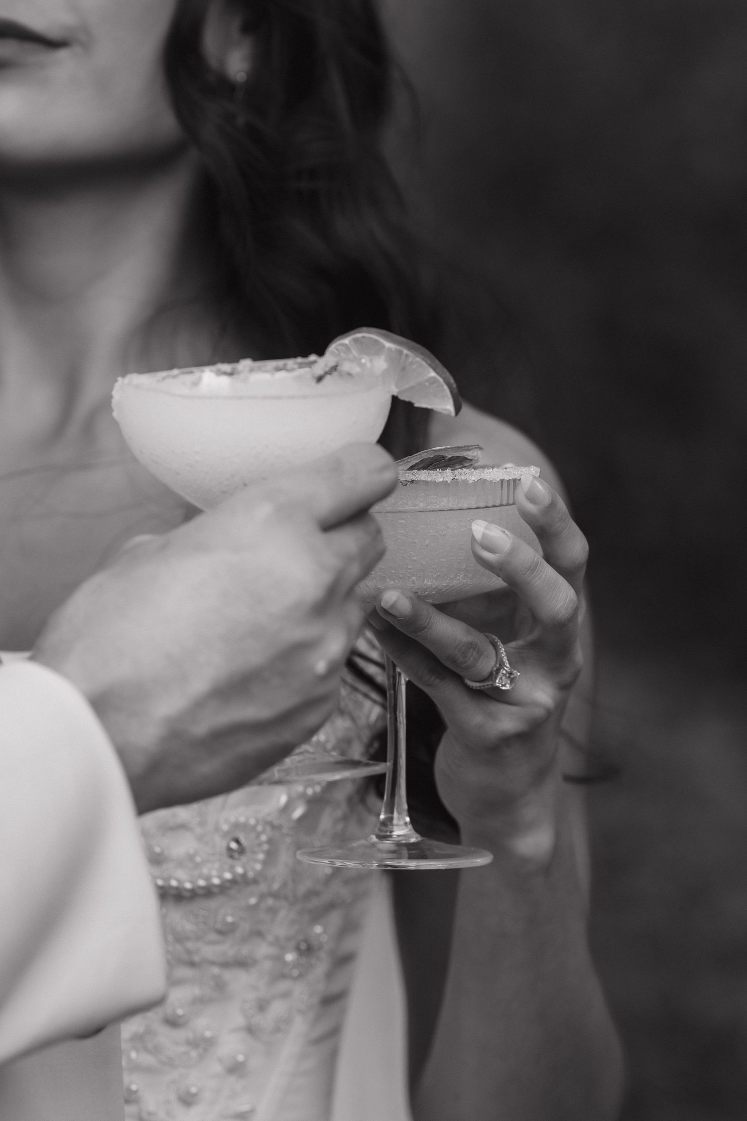 Black and white close-up shots of champagne glasses being raised in celebration.