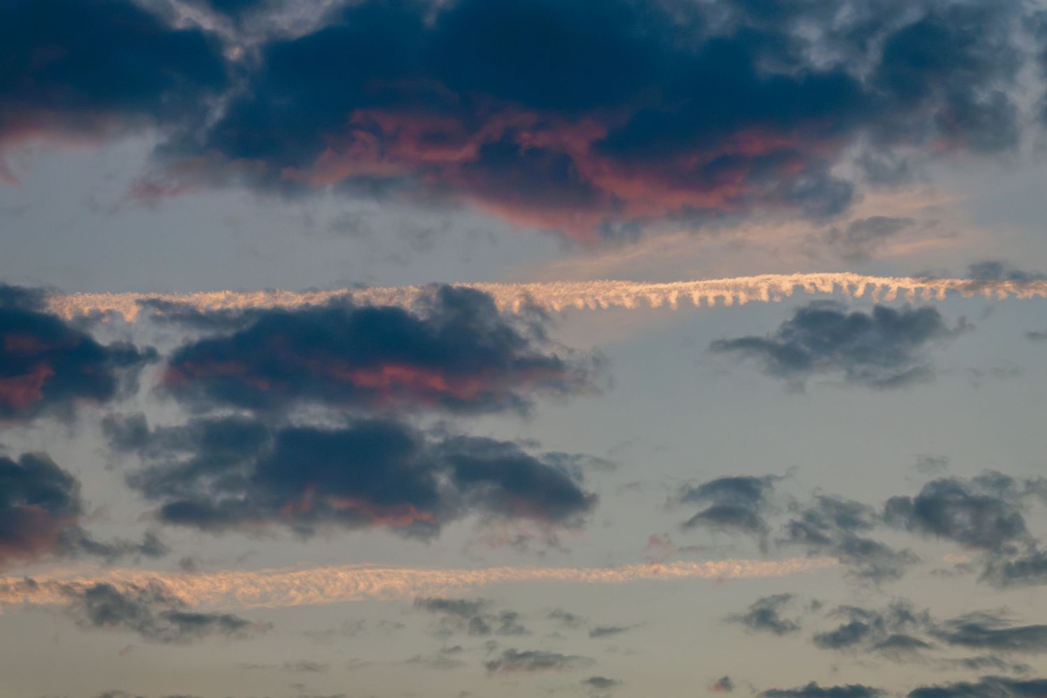 A dramatic sunset sky with pink and blue clouds creating a beautiful backdrop.