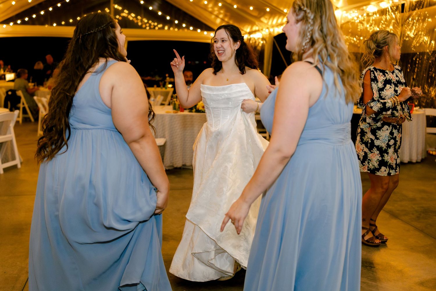 Wedding reception dance floor with string lights creating a warm golden ambiance.