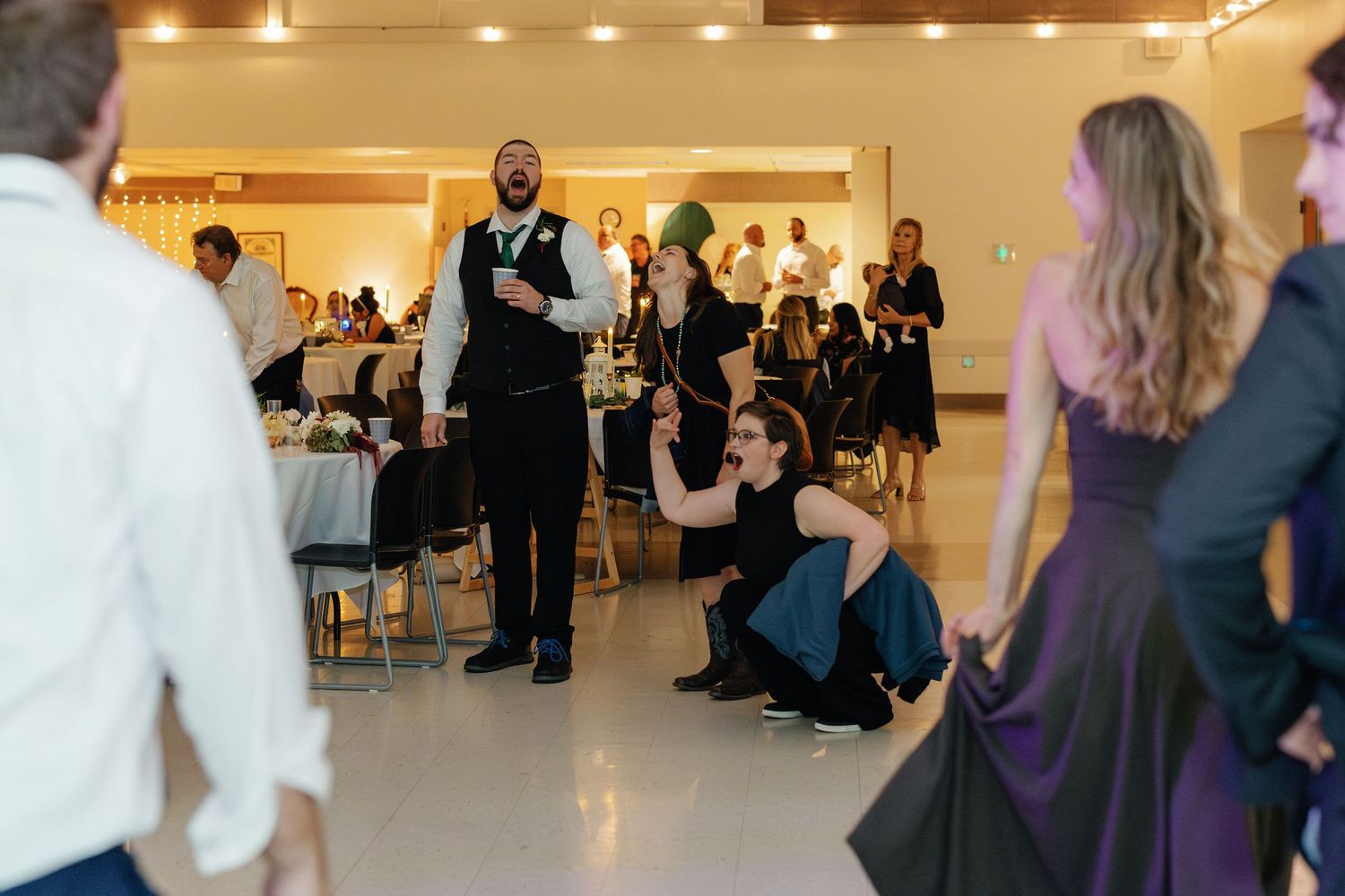 Wedding reception guests gathered on the dance floor during a celebration.