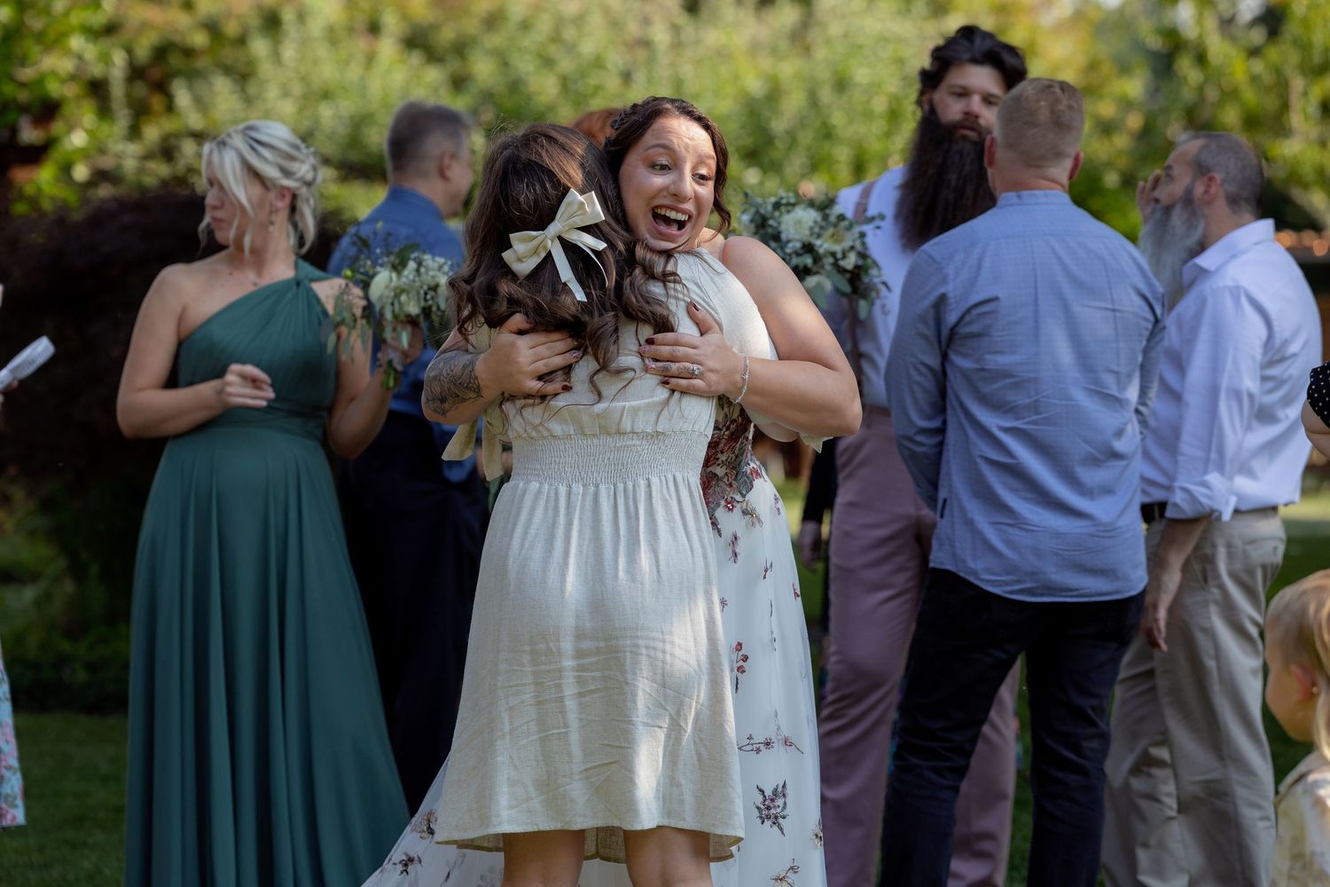 Wedding guests gathered outdoors for celebration in casual summer attire.