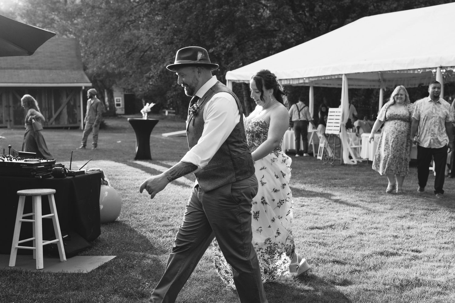 Guests enjoying outdoor activities and dancing at a casual summer gathering with lawn games and seating.