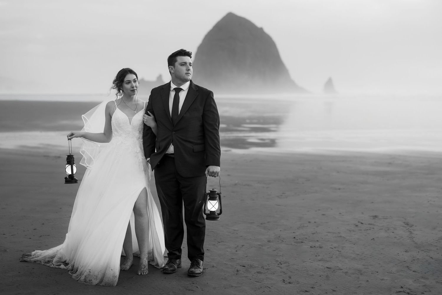 A romantic black and white beach wedding photo series showing couples walking along the shoreline at sunset.