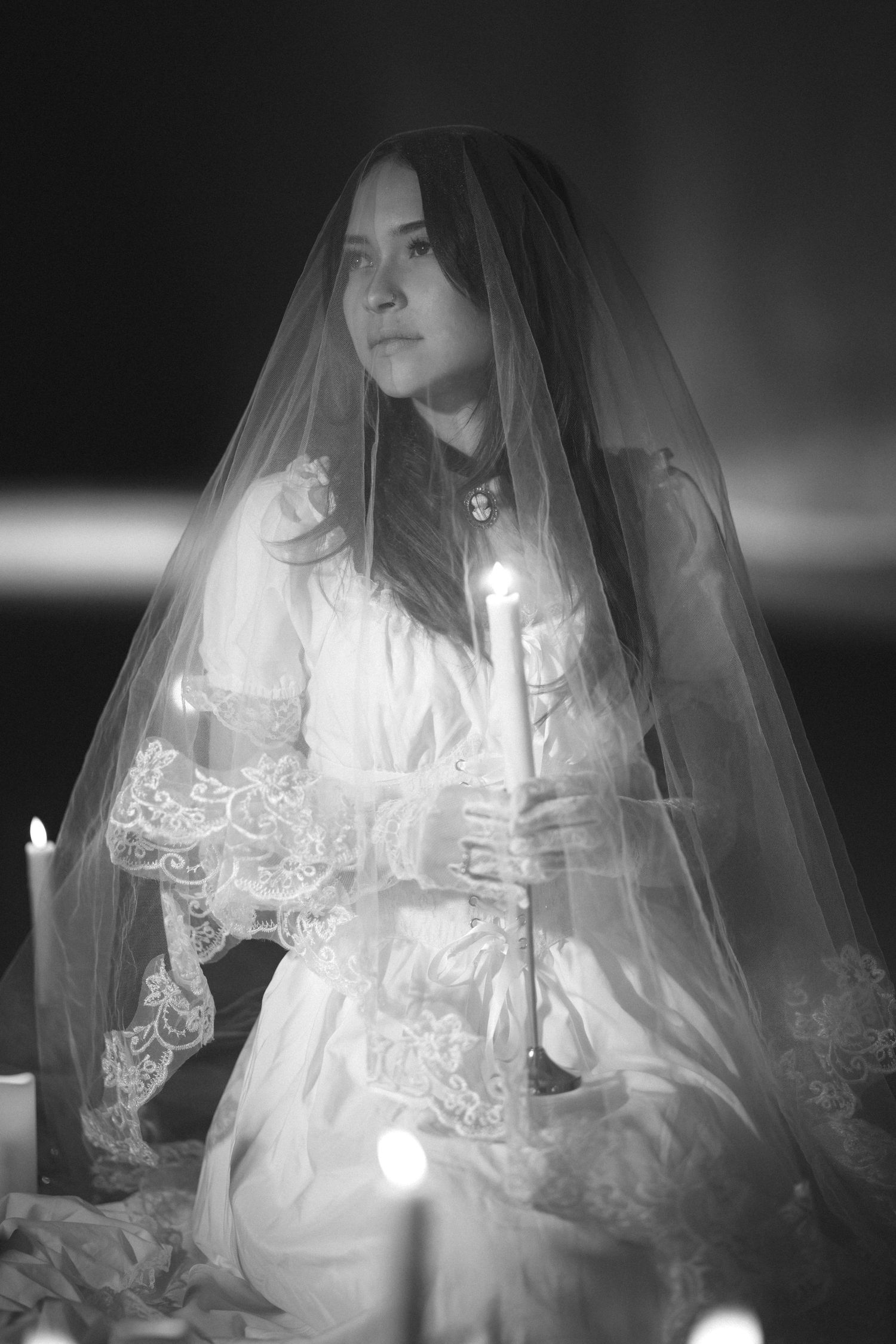 Ethereal black and white portrait series featuring a figure in white lace and veil.