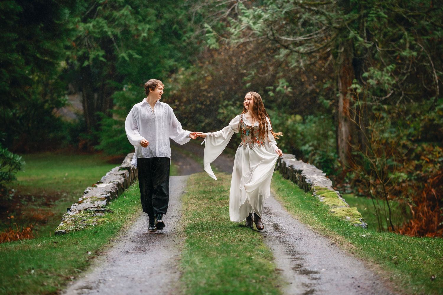 A couple walks together down a scenic tree-lined path on their special day.