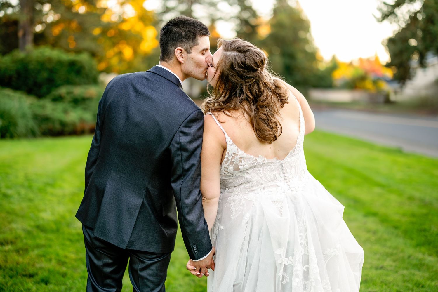 Romantic outdoor wedding portraits in garden setting during golden hour.