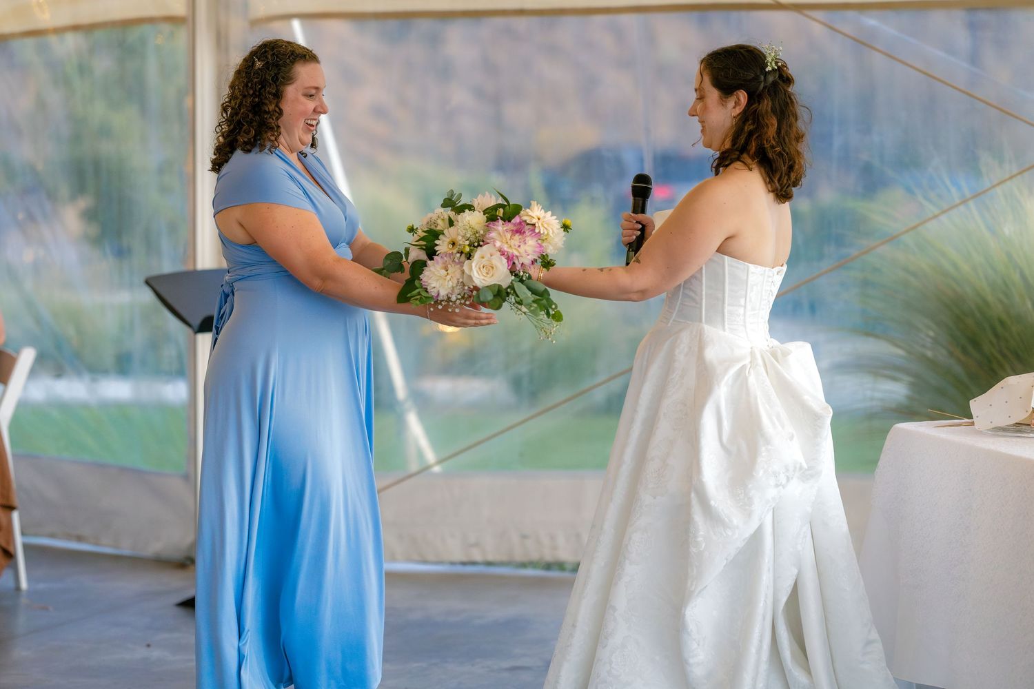Wedding party members in light blue dresses and white gowns gathered outdoors.