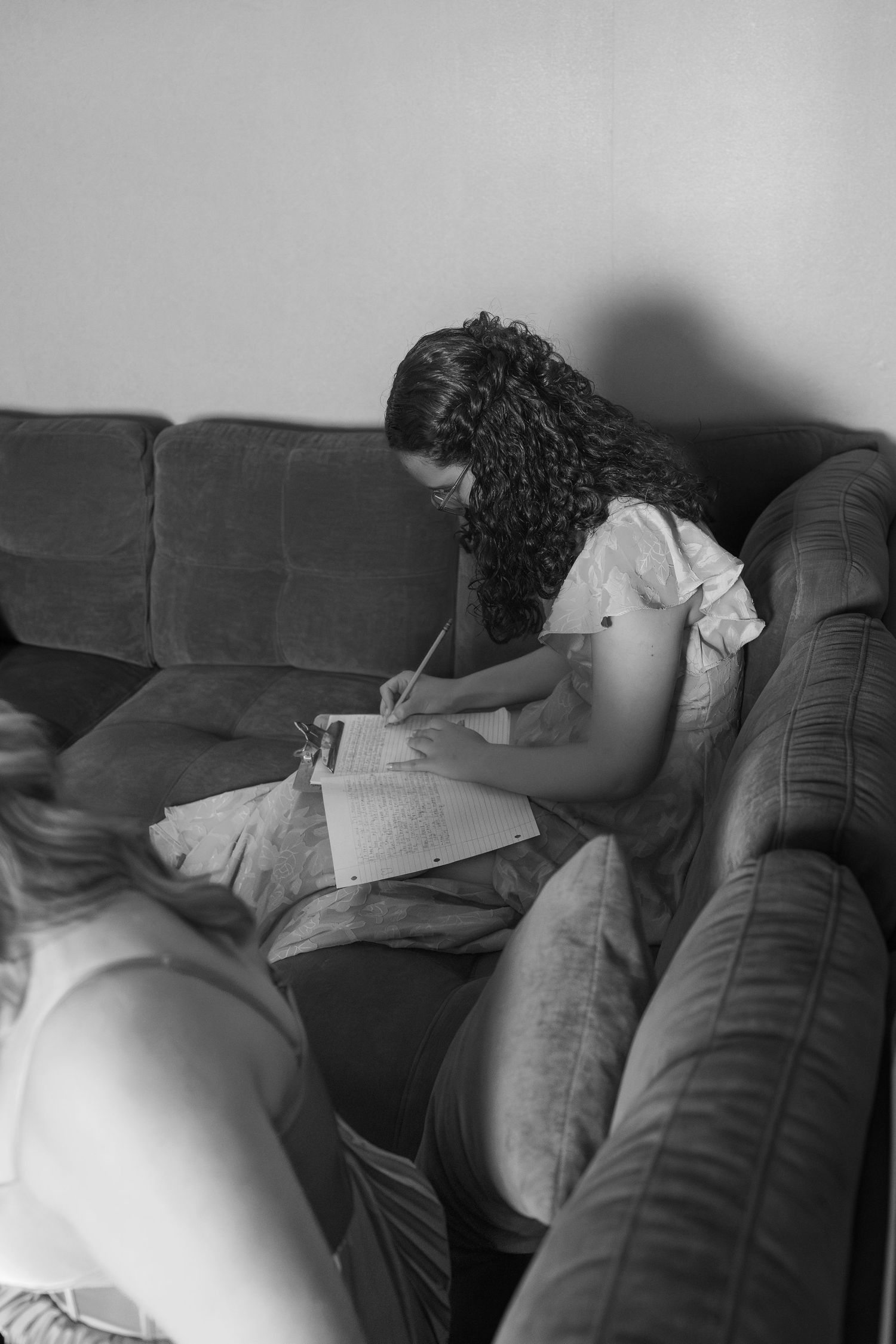 Series of black and white photos showing someone resting on a dark couch.