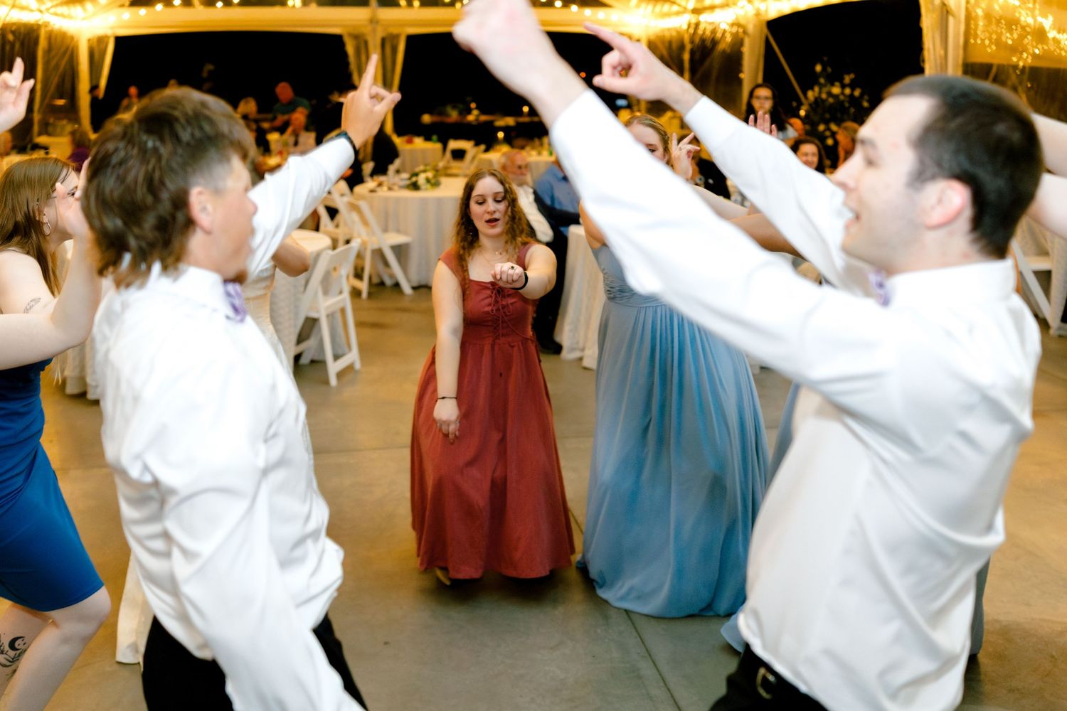 Wedding party dancing and celebrating on the reception dance floor.