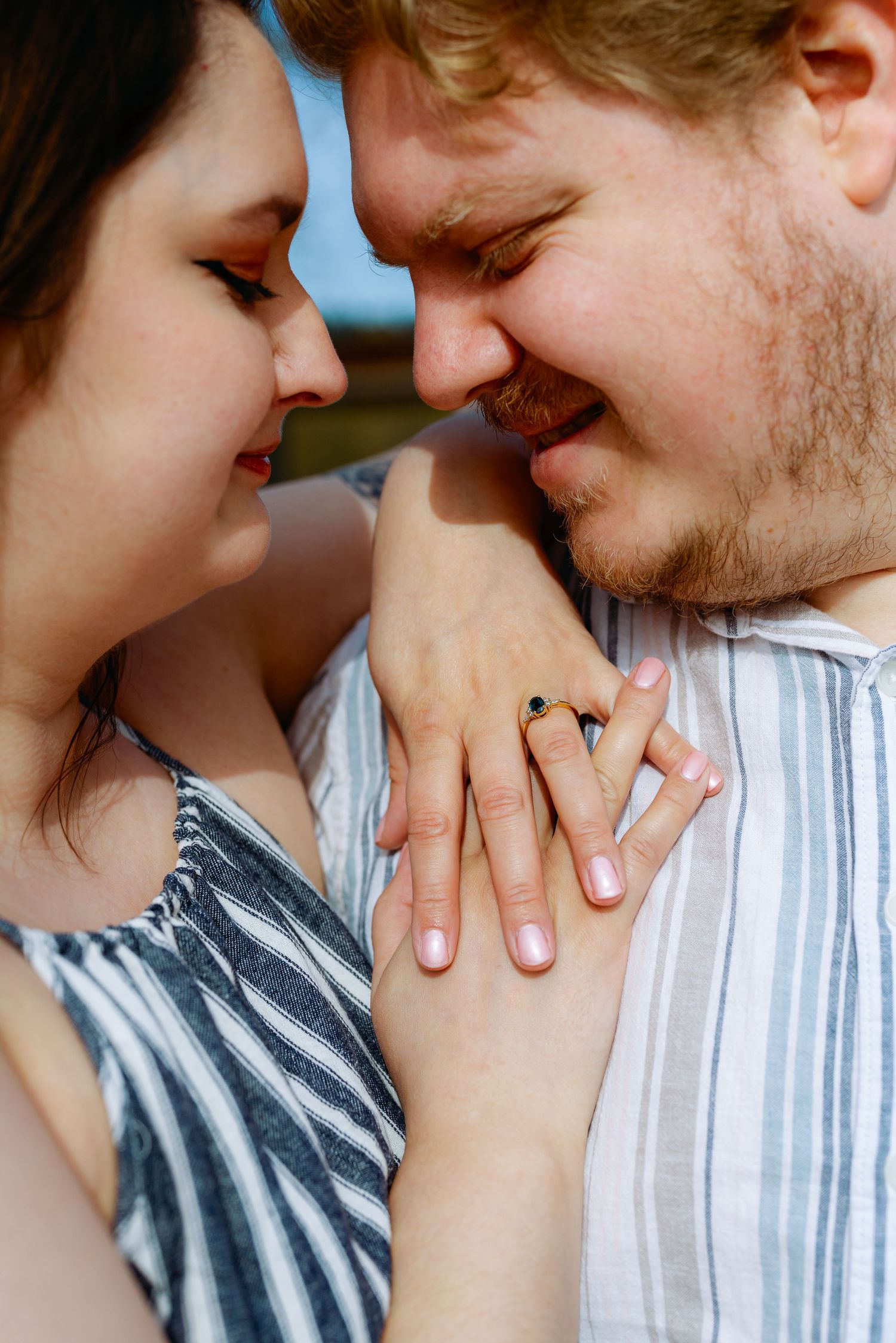 A romantic close-up sequence showing an intimate moment between a couple in casual striped clothing.