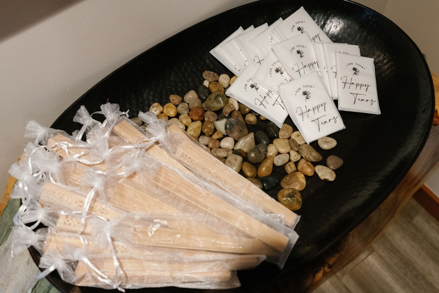 Wedding favors and small gift cards arranged on a black surface.