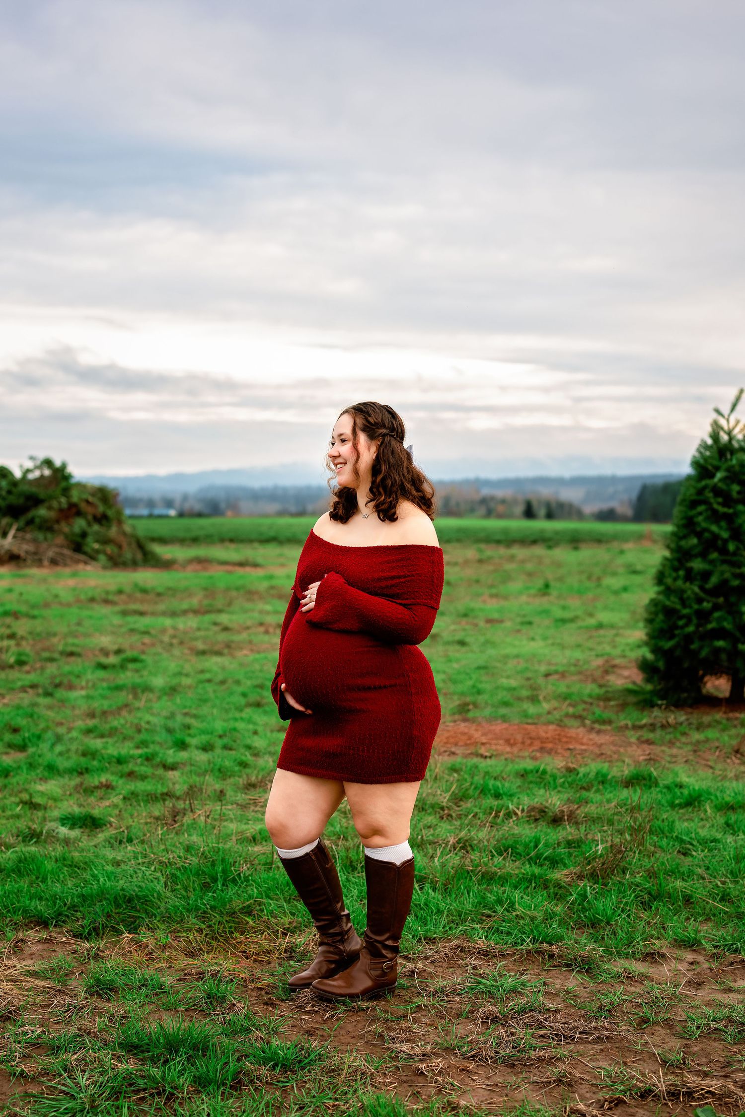 Three outdoor shots of someone wearing a burgundy sweater and brown boots in a green field with mountains in background.