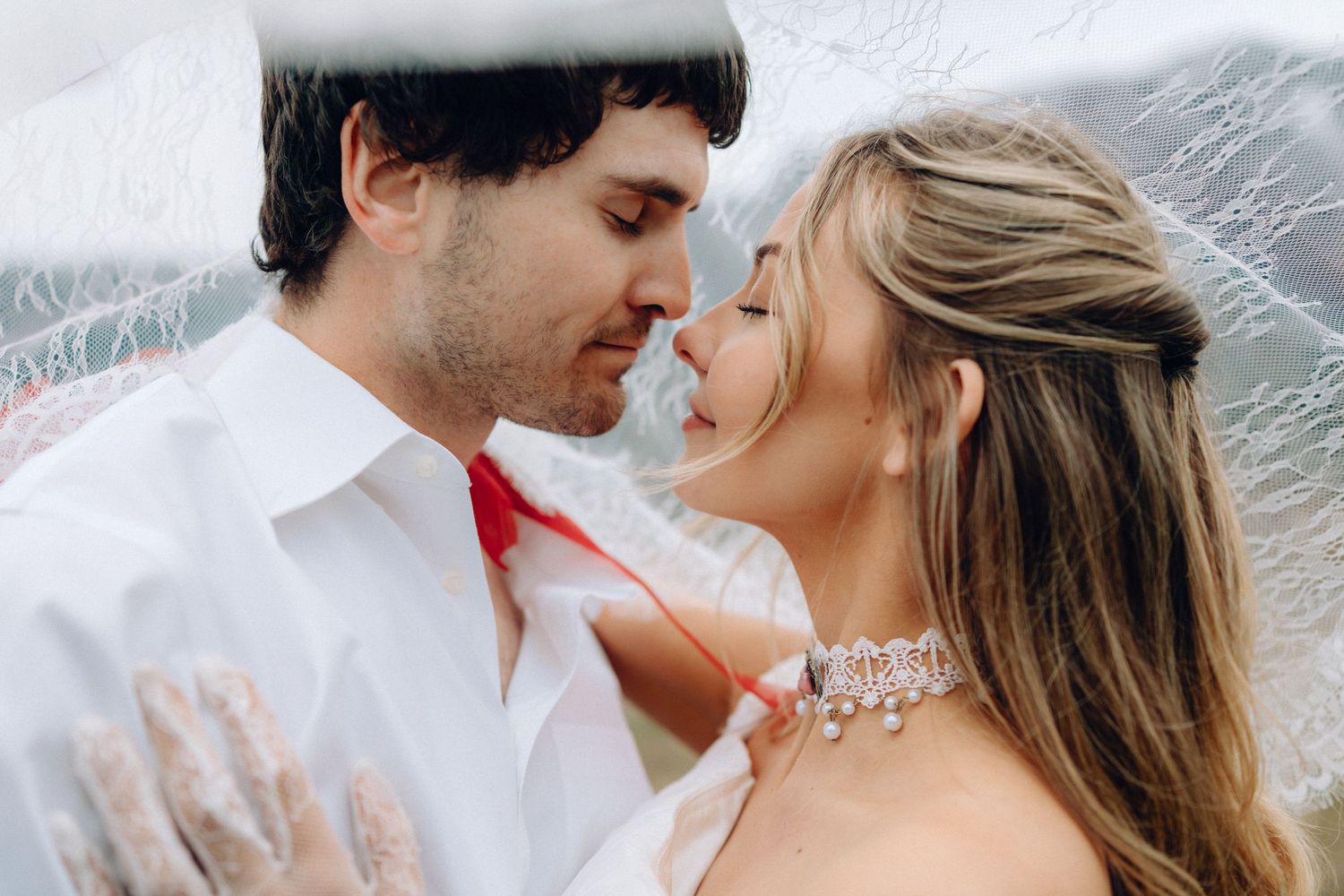 Romantic couple in formal attire share intimate moments in a series of black and white wedding photos.