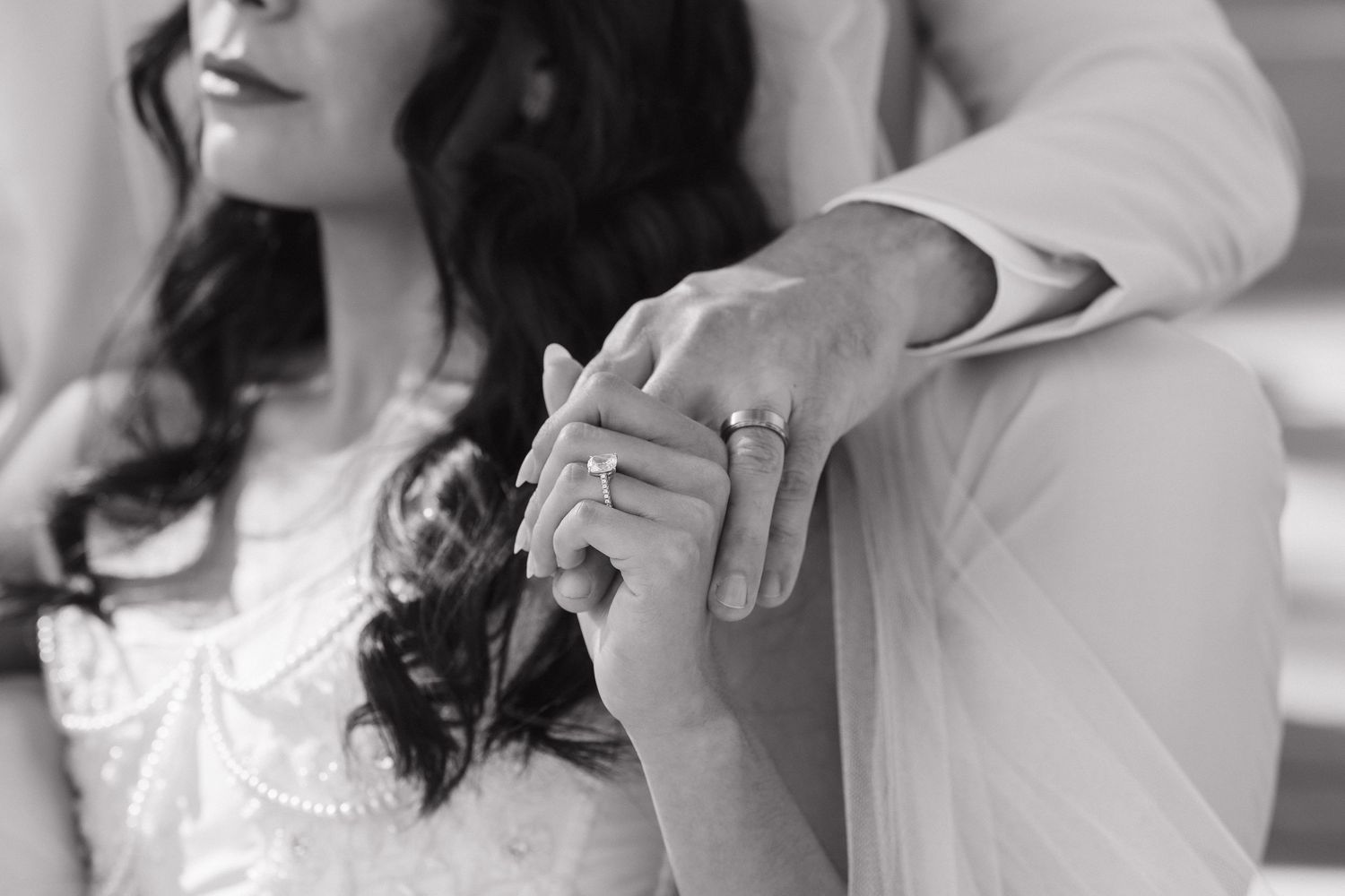 A person in white clothing adjusts their hair while getting ready for a special occasion.