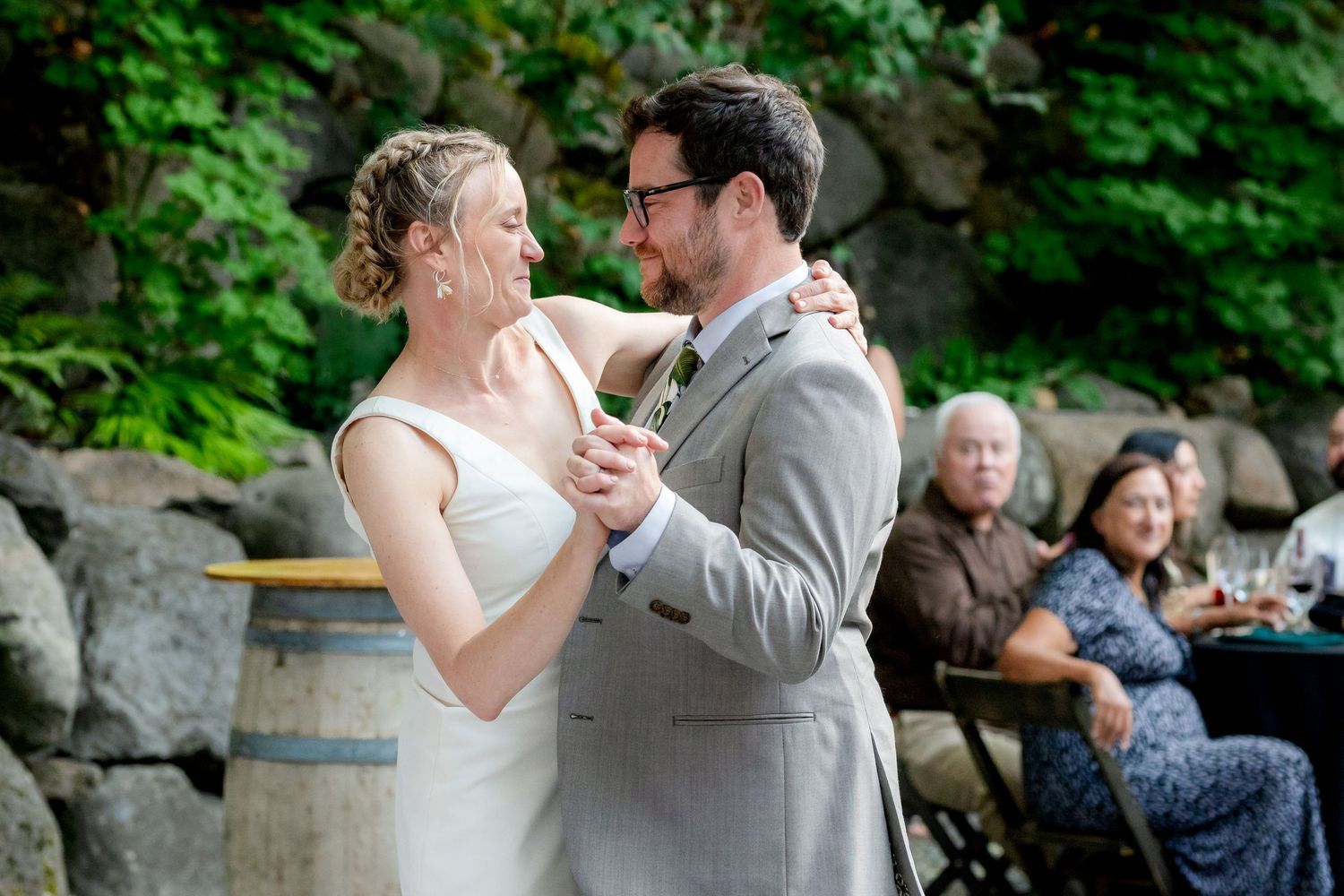 Bride and groom sharing first dance at outdoor wedding reception.