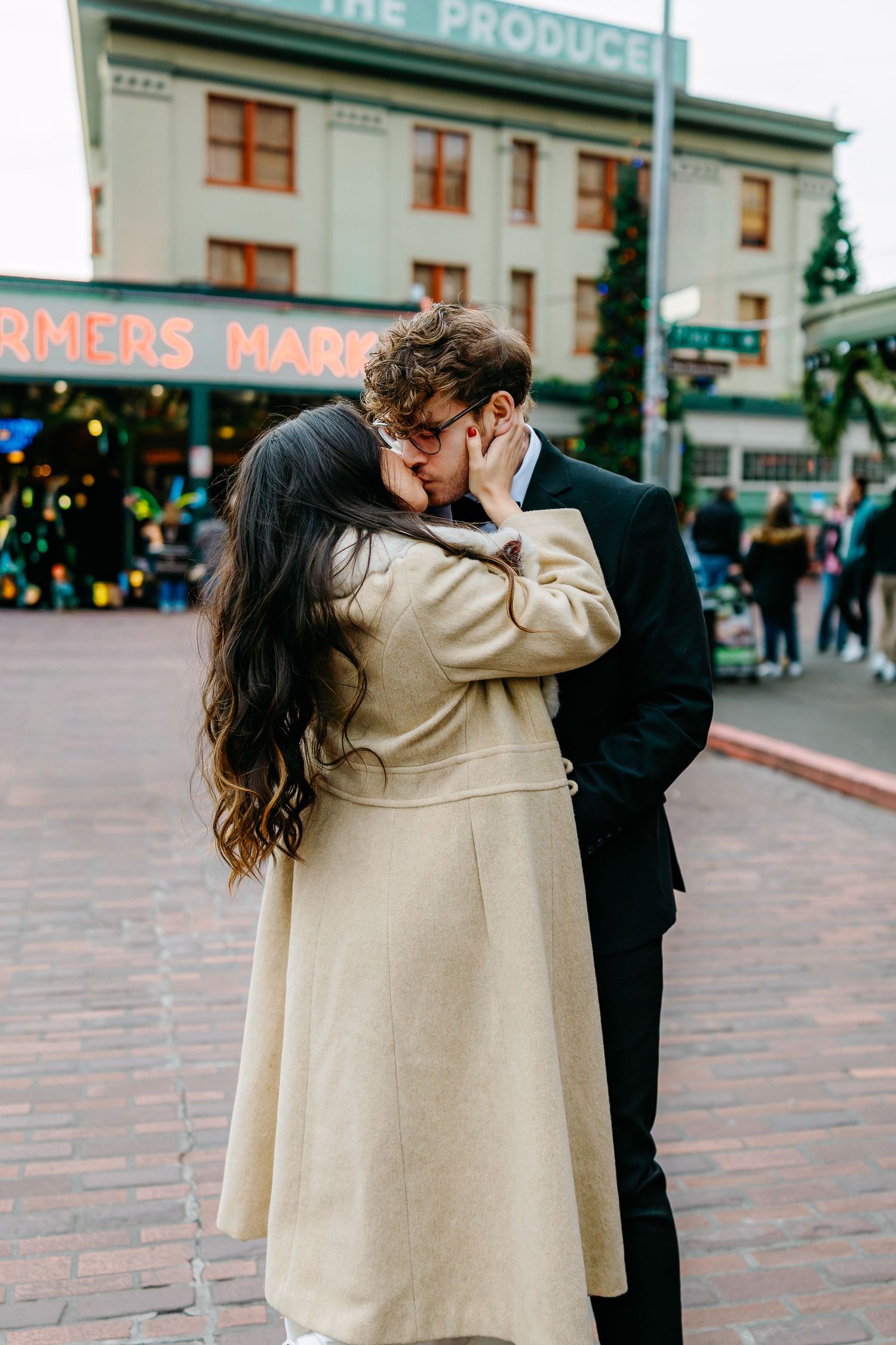 A romantic moment shared between a couple outside Pike Place Market in Seattle.