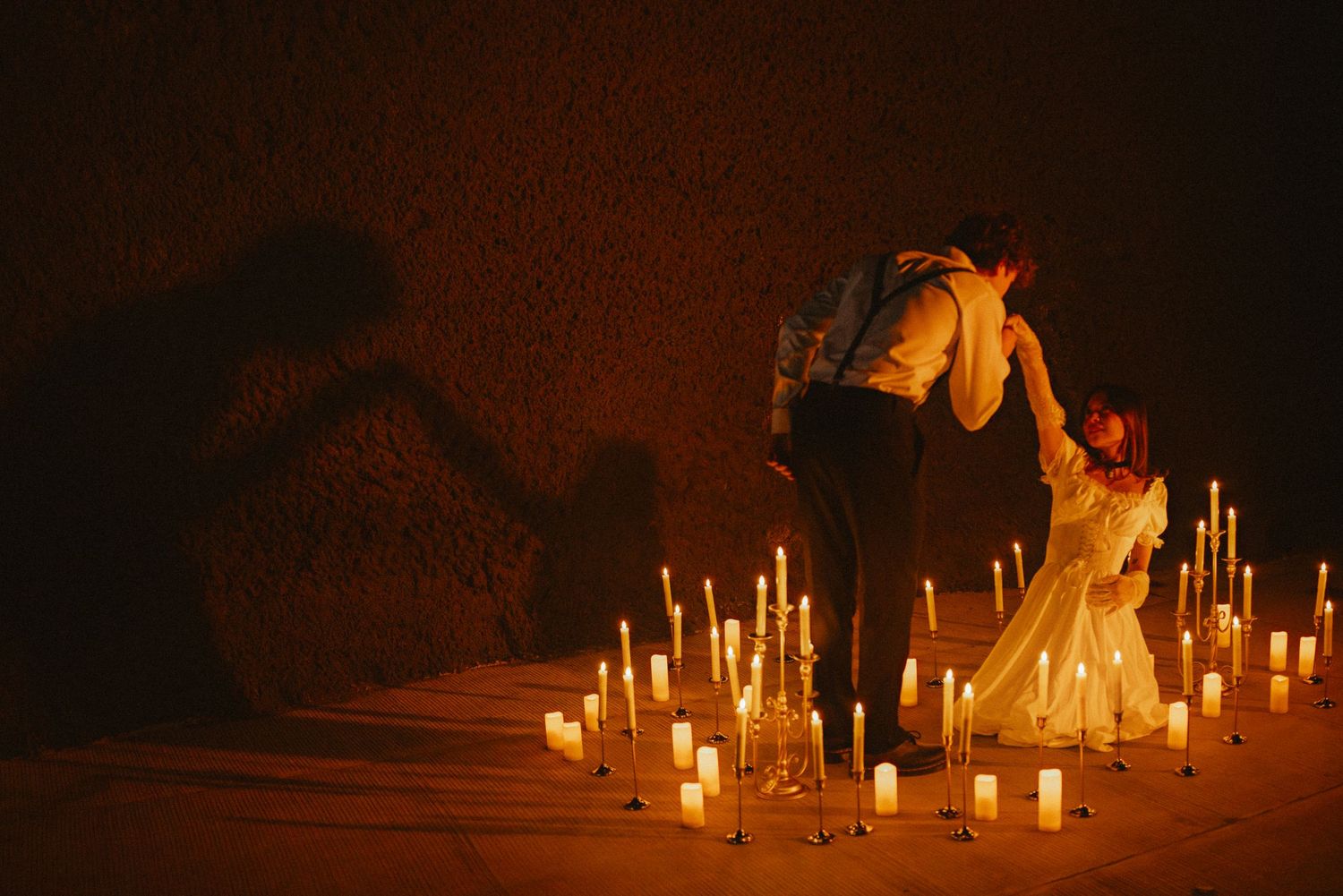 Multiple candles illuminate a dark landscape creating a mystical nighttime scene.