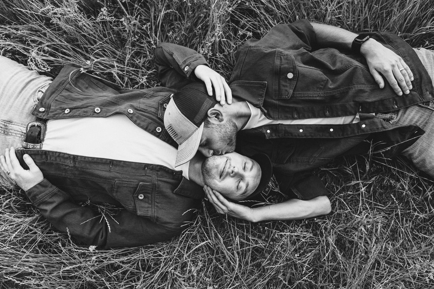 Black and white photo series showing someone lying in grass wearing vintage clothing and looking up at the camera.