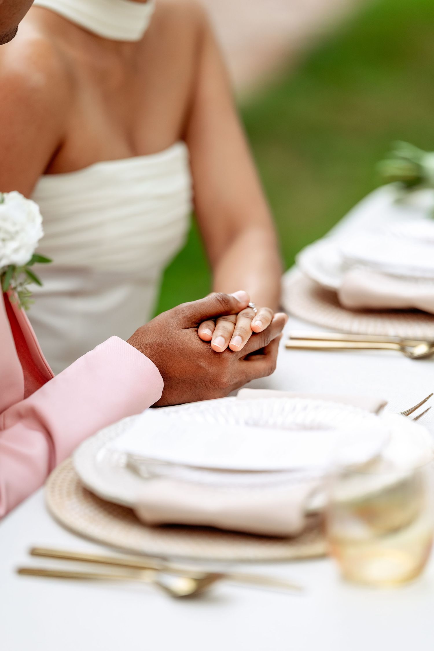 Wedding table setting with white linens and elegant place settings.