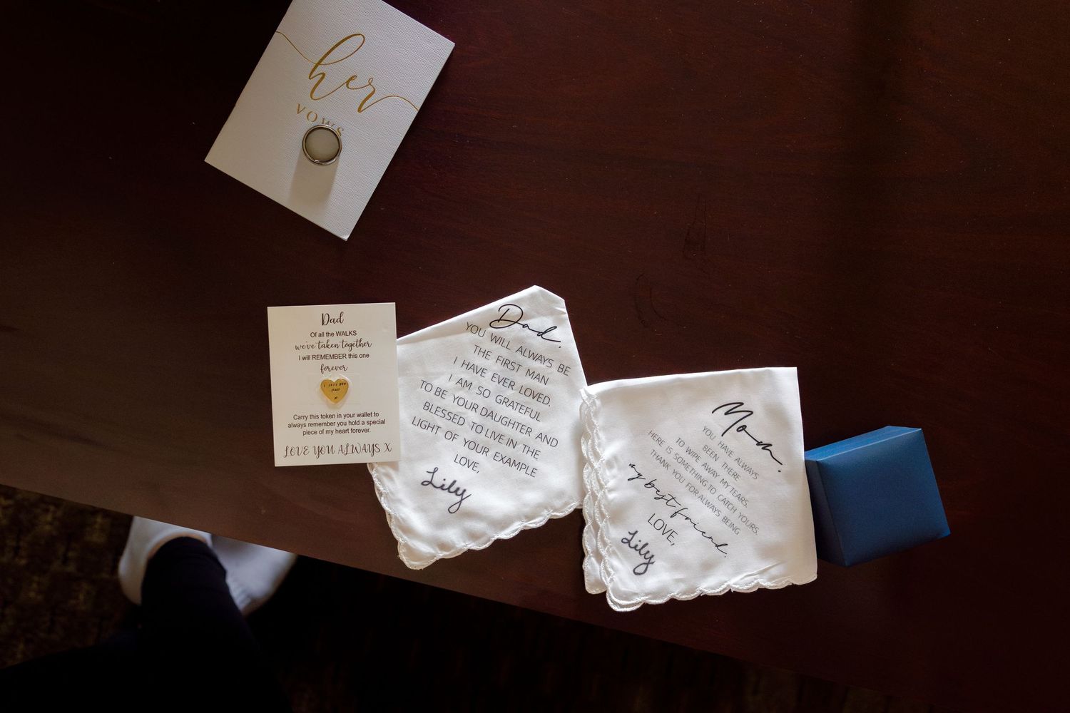 Several small paper receipts scattered on a dark wooden surface.