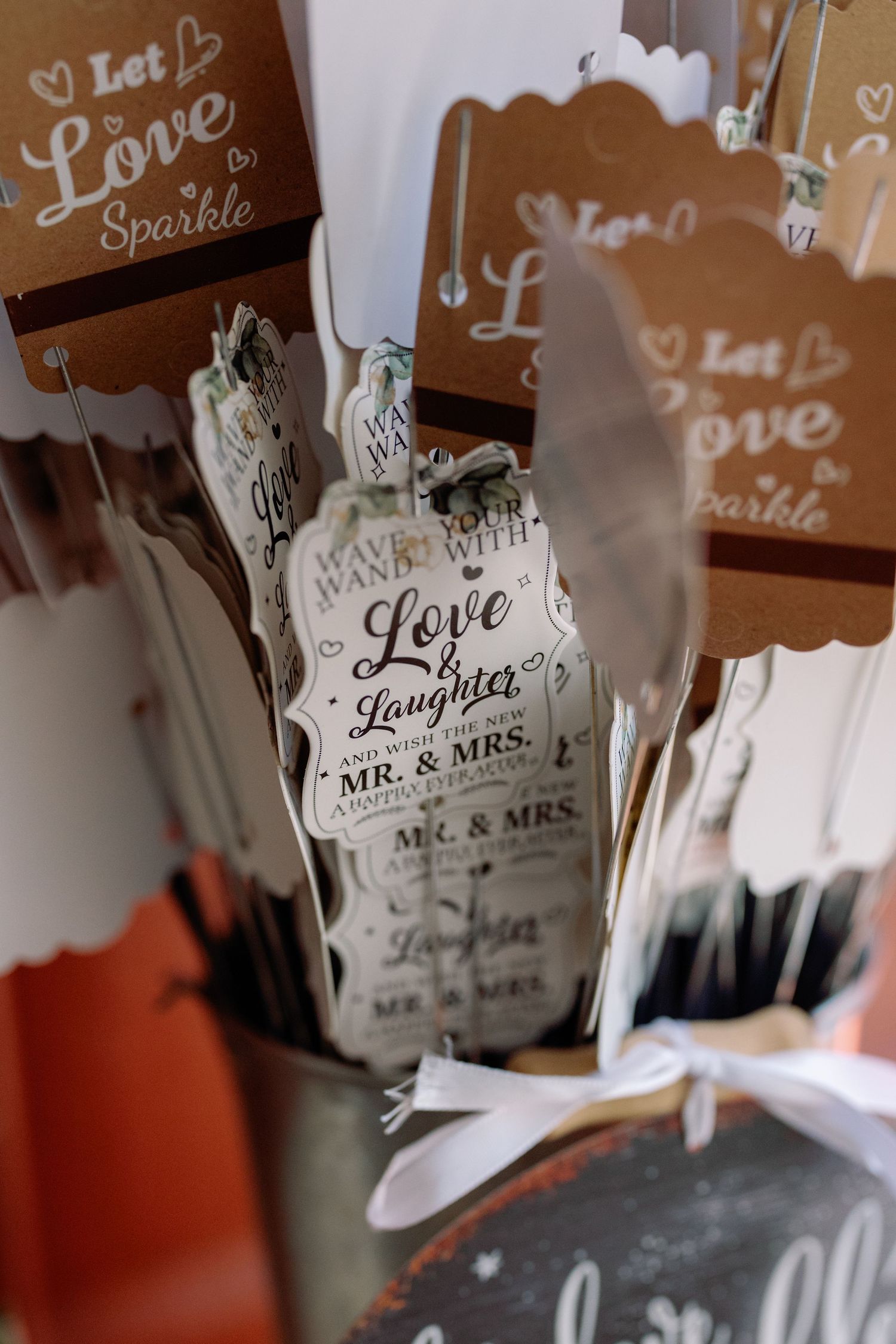 Wedding decorations with hanging signs featuring words like 'Love' and 'Laughter' create a romantic atmosphere.