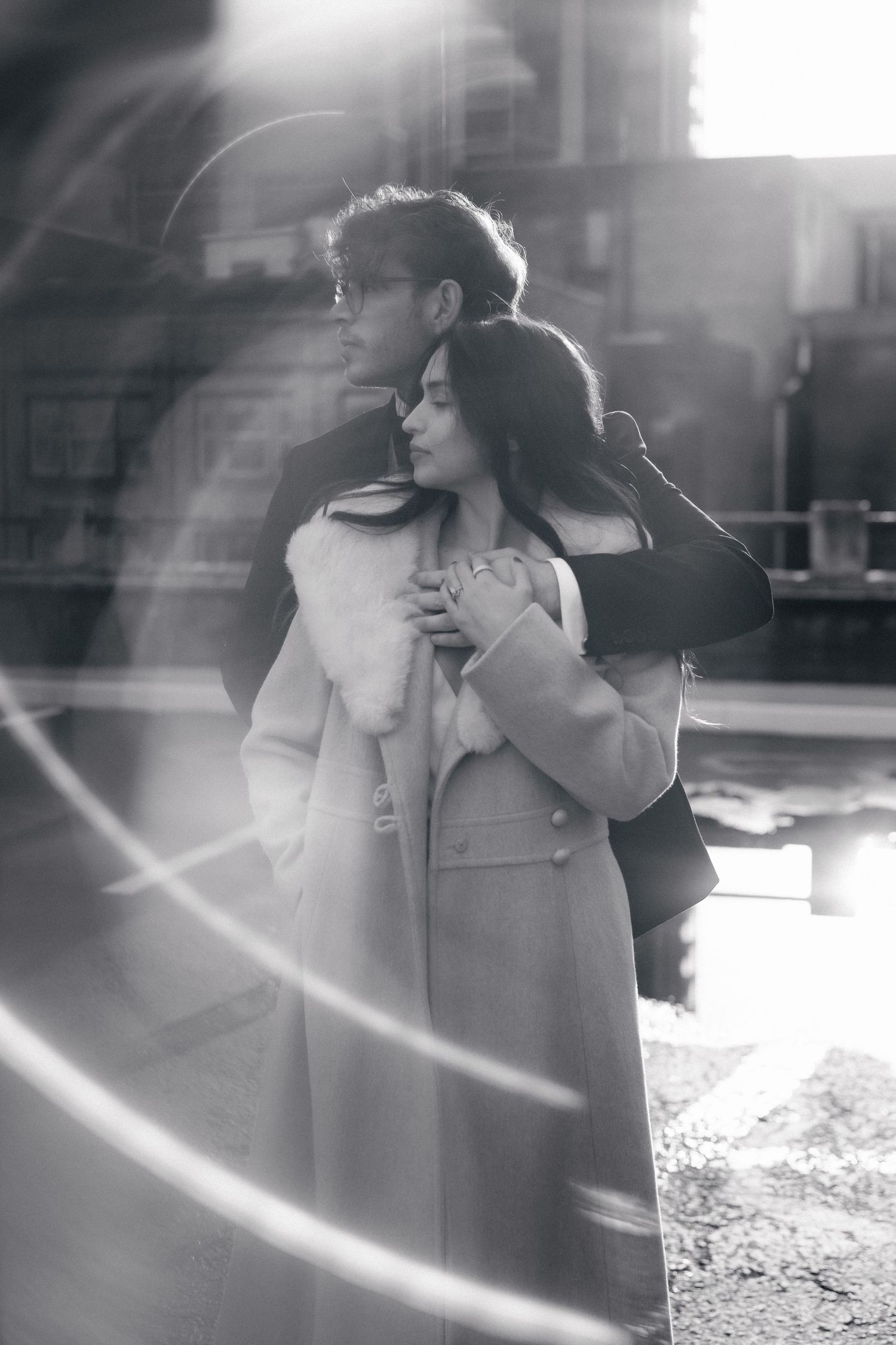 A dreamy black and white sequence of a couple embracing with lens flare effects.