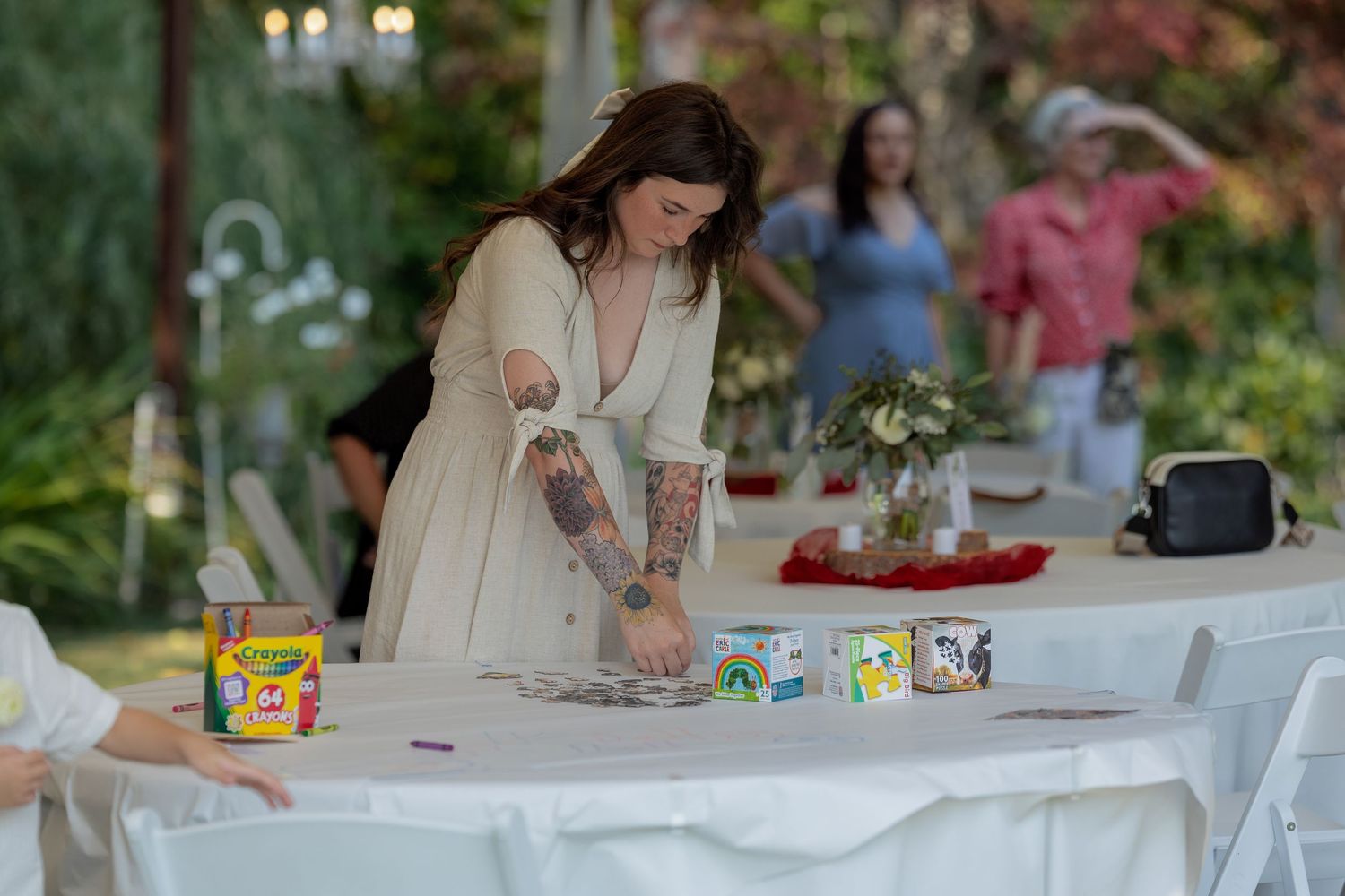 Reception table setup with refreshments and decorations in an outdoor garden setting.