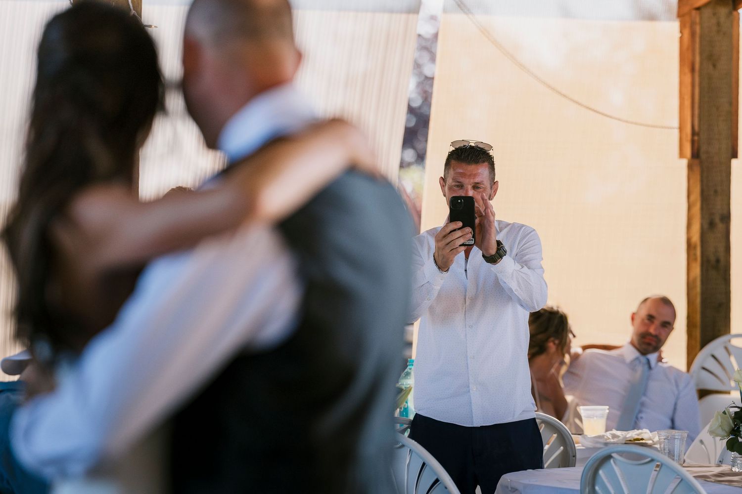 A couple shares their first dance together during a joyful wedding reception celebration.