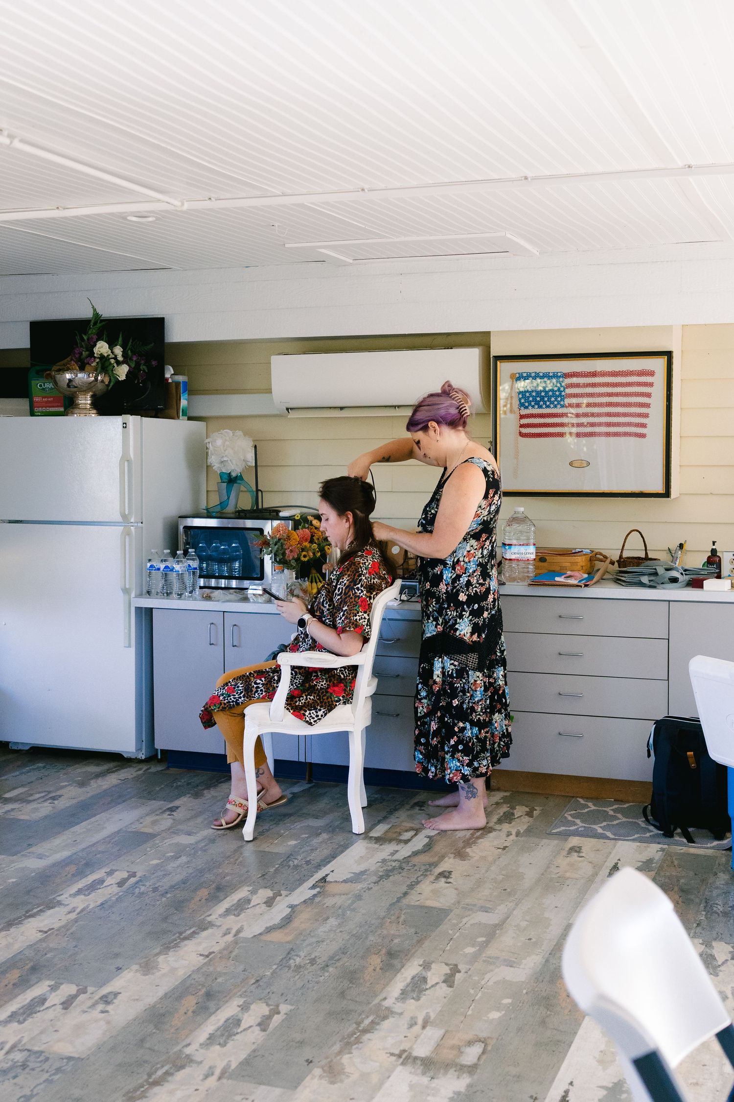 Interior room with white cabinets and American flag decor being prepared for event.