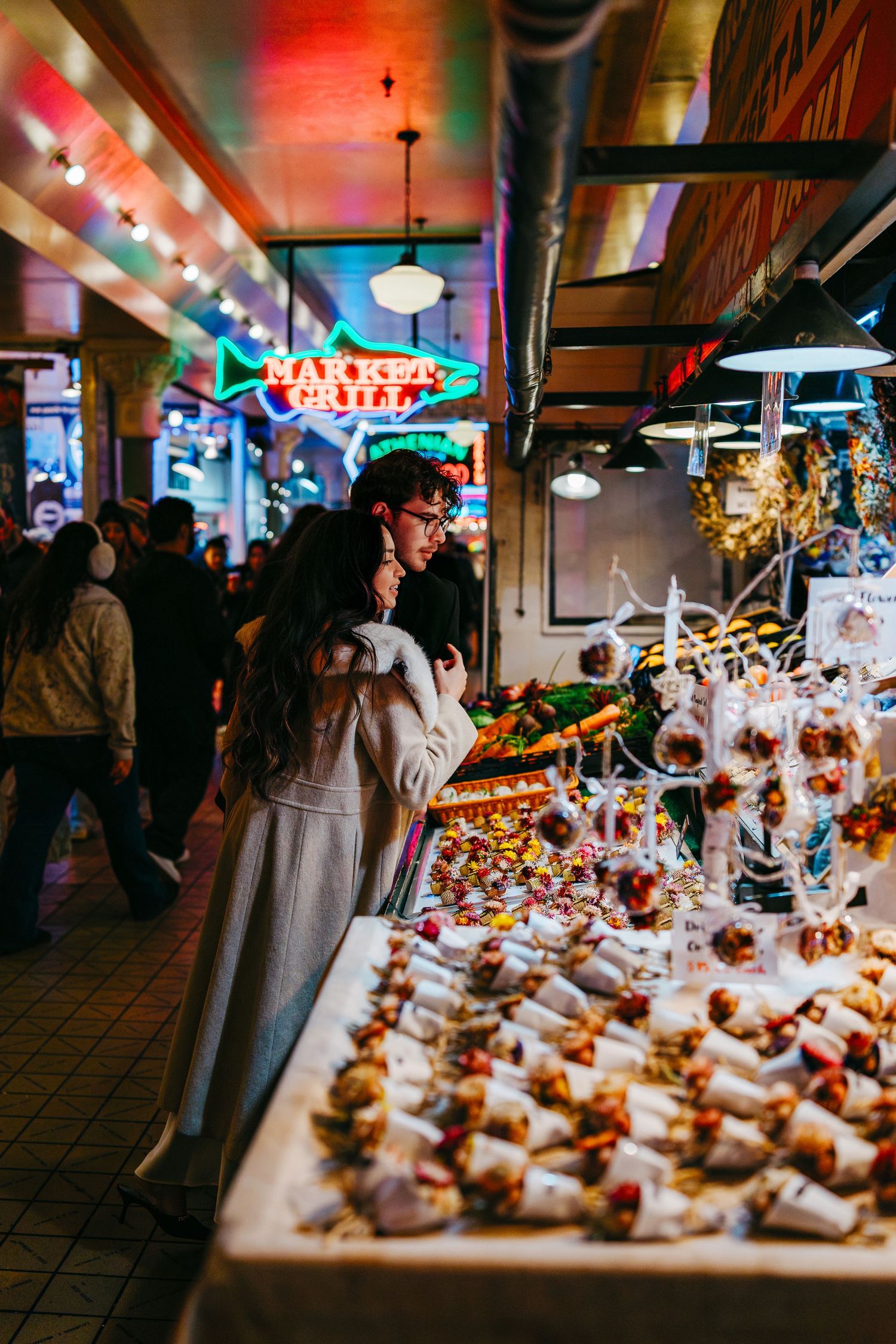 Elegant dessert display at an event featuring rows of beautifully plated mini desserts under warm lighting.