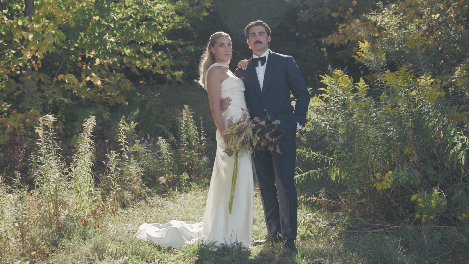 Bride and groom embracing during outside wedding ceremony in Hudson Valley NY captured in documentary film style